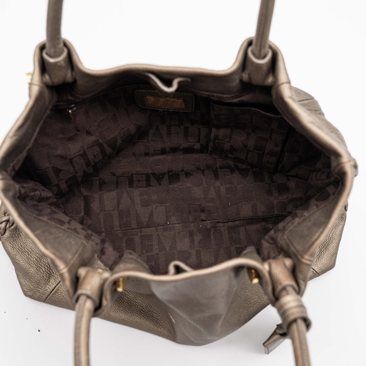 Furla taupe leather shoulder bag with gold hardware and braided detailing, photographed against a white background.