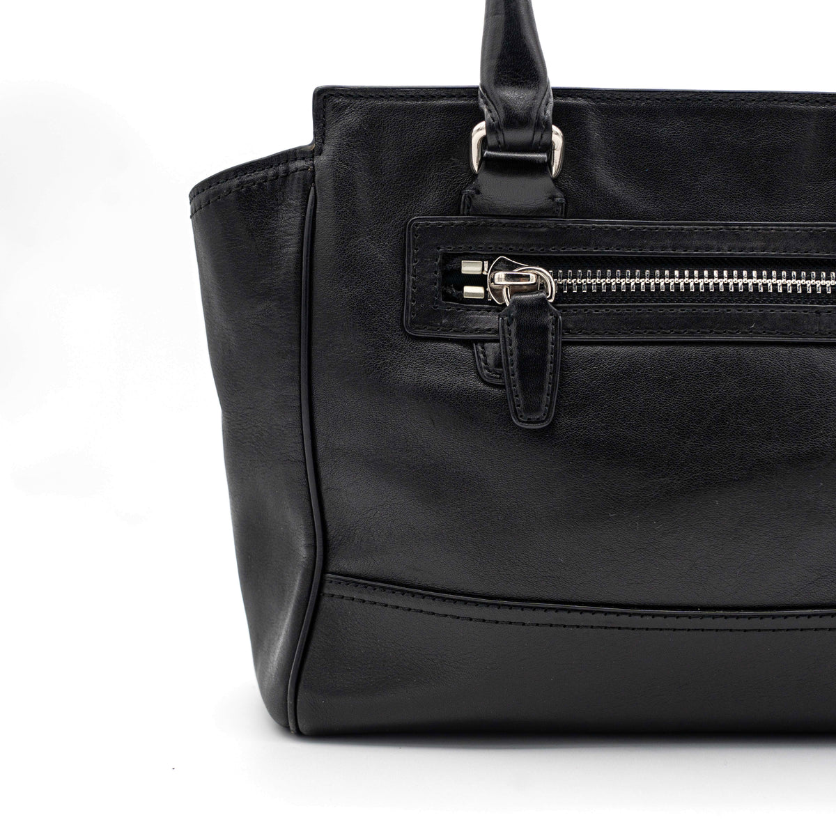 Coach Legacy Candace Carryall in black leather with double tassel charm and silver hardware, photographed against a white background.