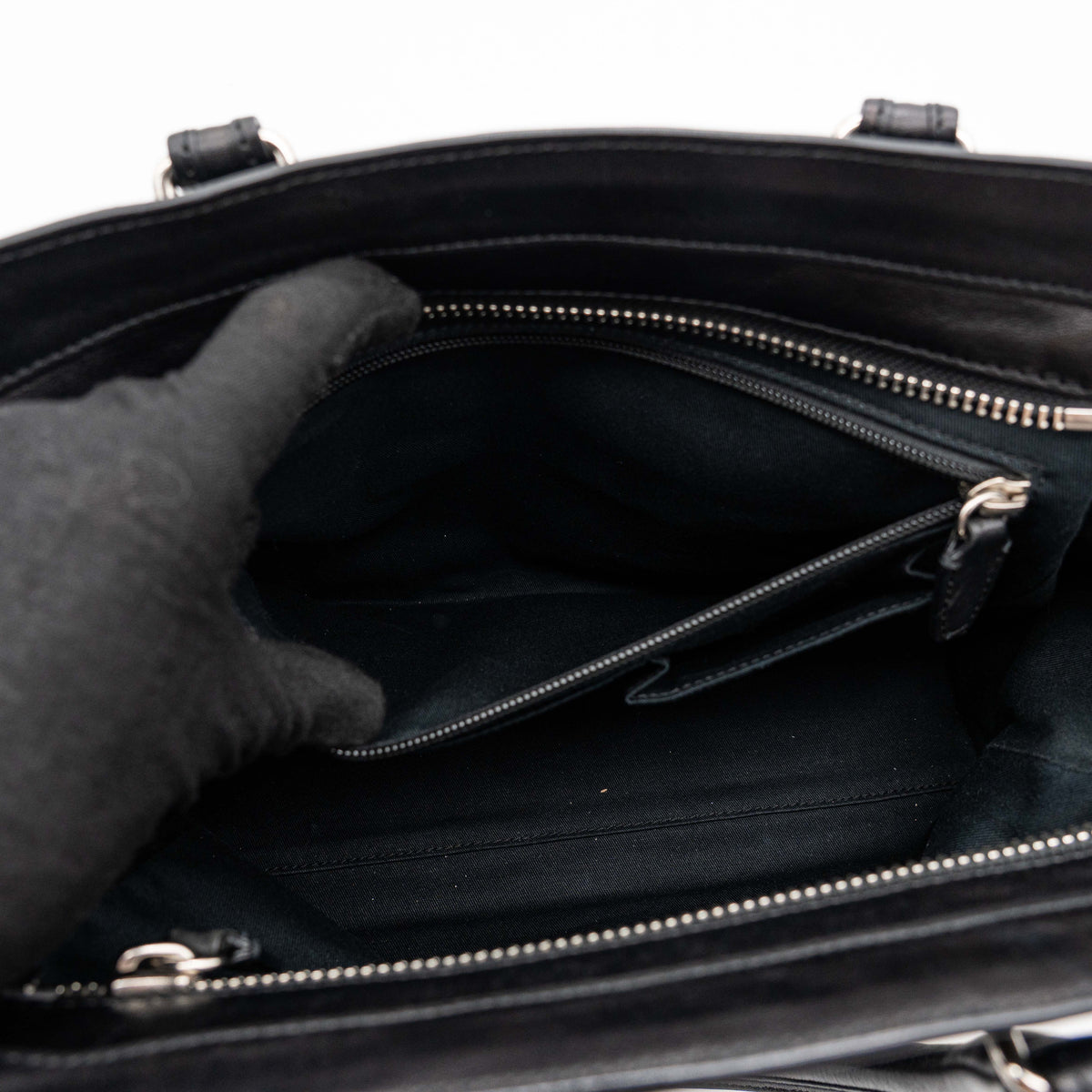 Coach Legacy Candace Carryall in black leather with double tassel charm and silver hardware, photographed against a white background.