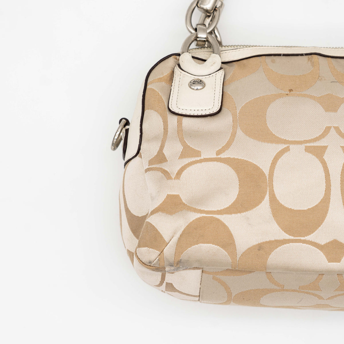 Coach Signature Kristin Satchel handbag in beige and cream jacquard with leather trim and detachable strap, displayed against a white background.