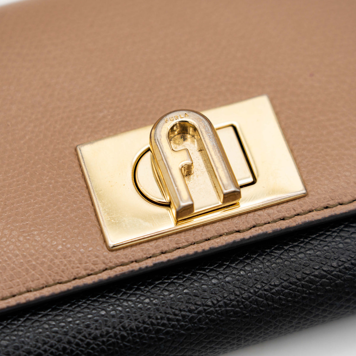 Furla 1927 M Compact Wallet in brown and black leather with gold hardware, photographed front facing on a white background.