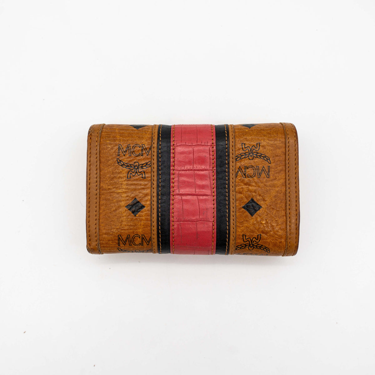 Front view of the MCM Cognac Visetos Monogram Stripe Trifold Wallet in brown with red and black accents and gold logo plaque.