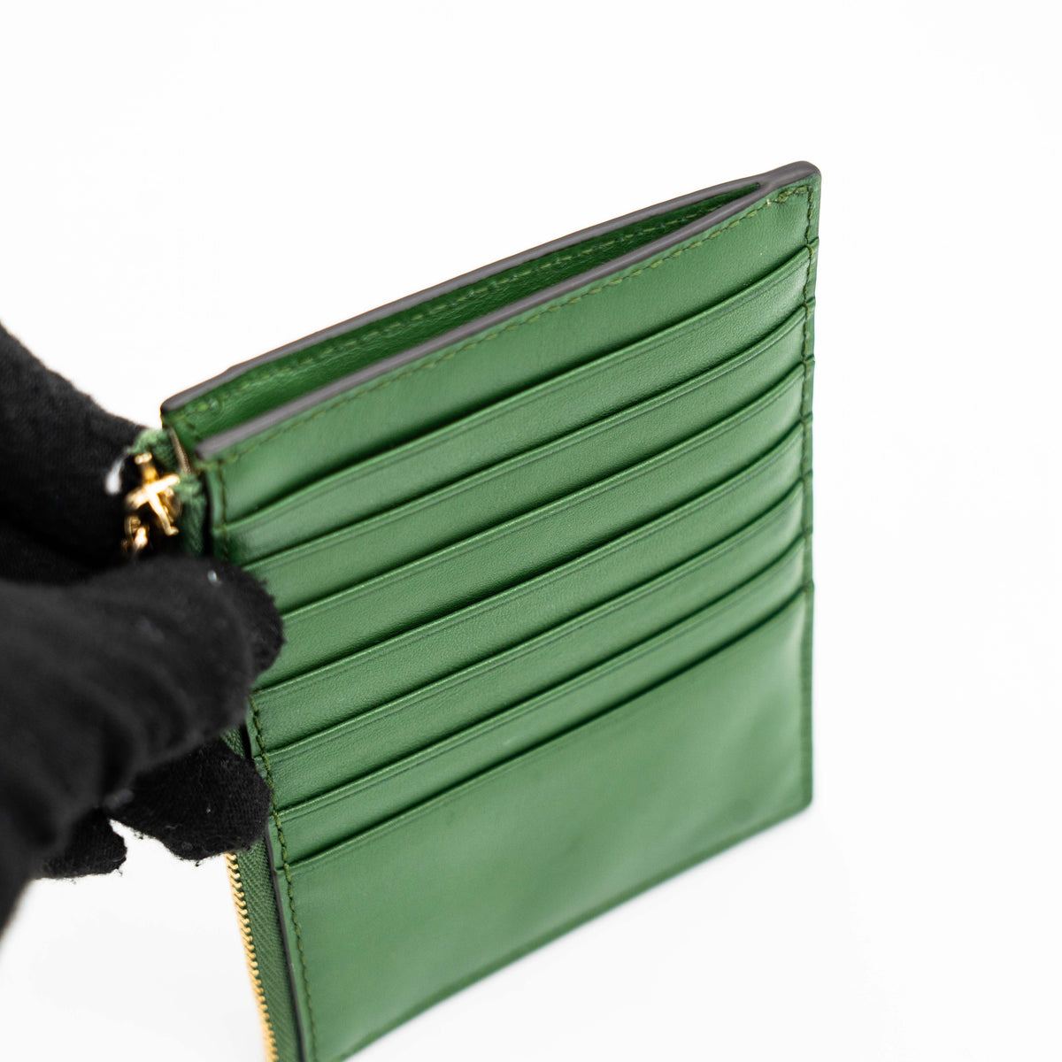 Furla Camelia S zipped card case in green leather with gold hardware and multiple card slots.