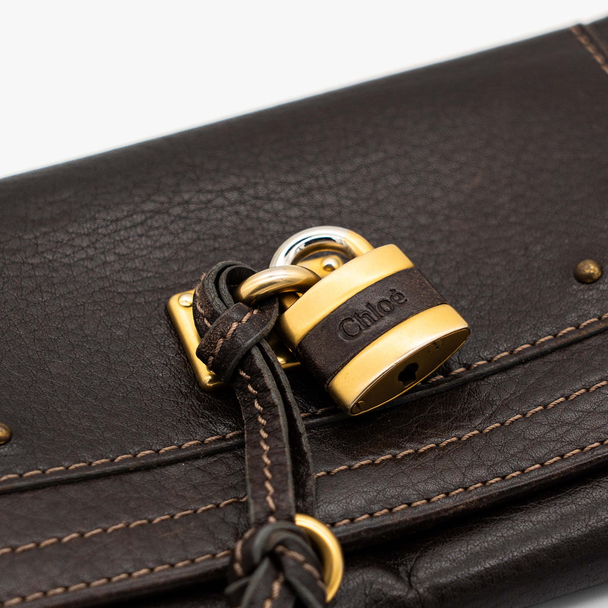 Chloé Paddington long wallet in dark brown leather with signature gold-tone padlock on the front.