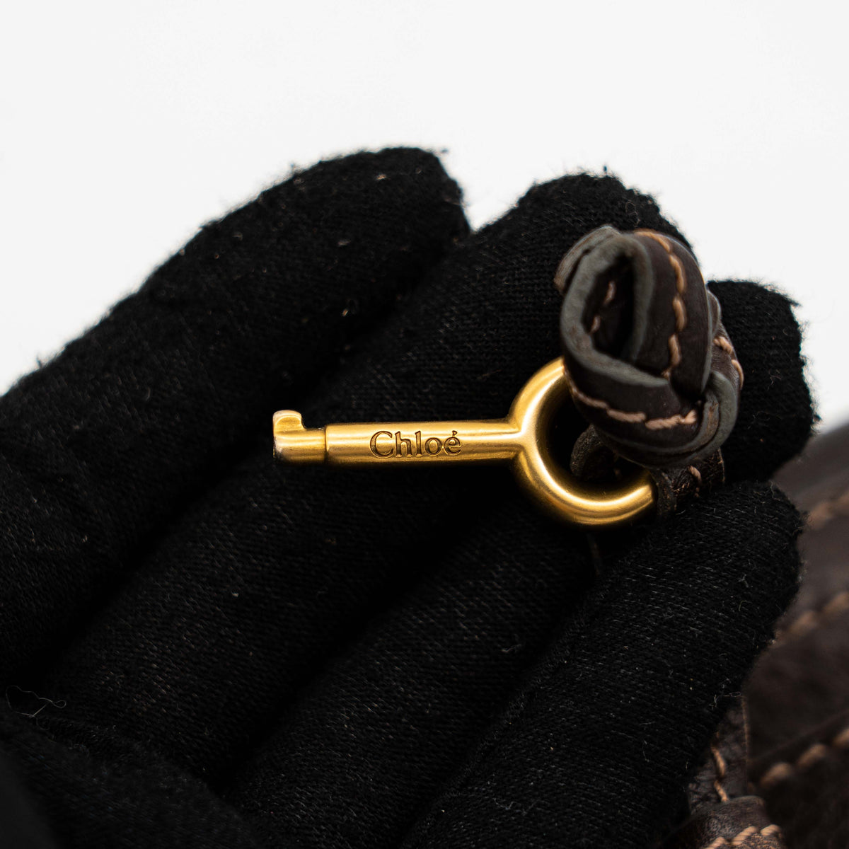 Chloé Paddington long wallet in dark brown leather with signature gold-tone padlock on the front.