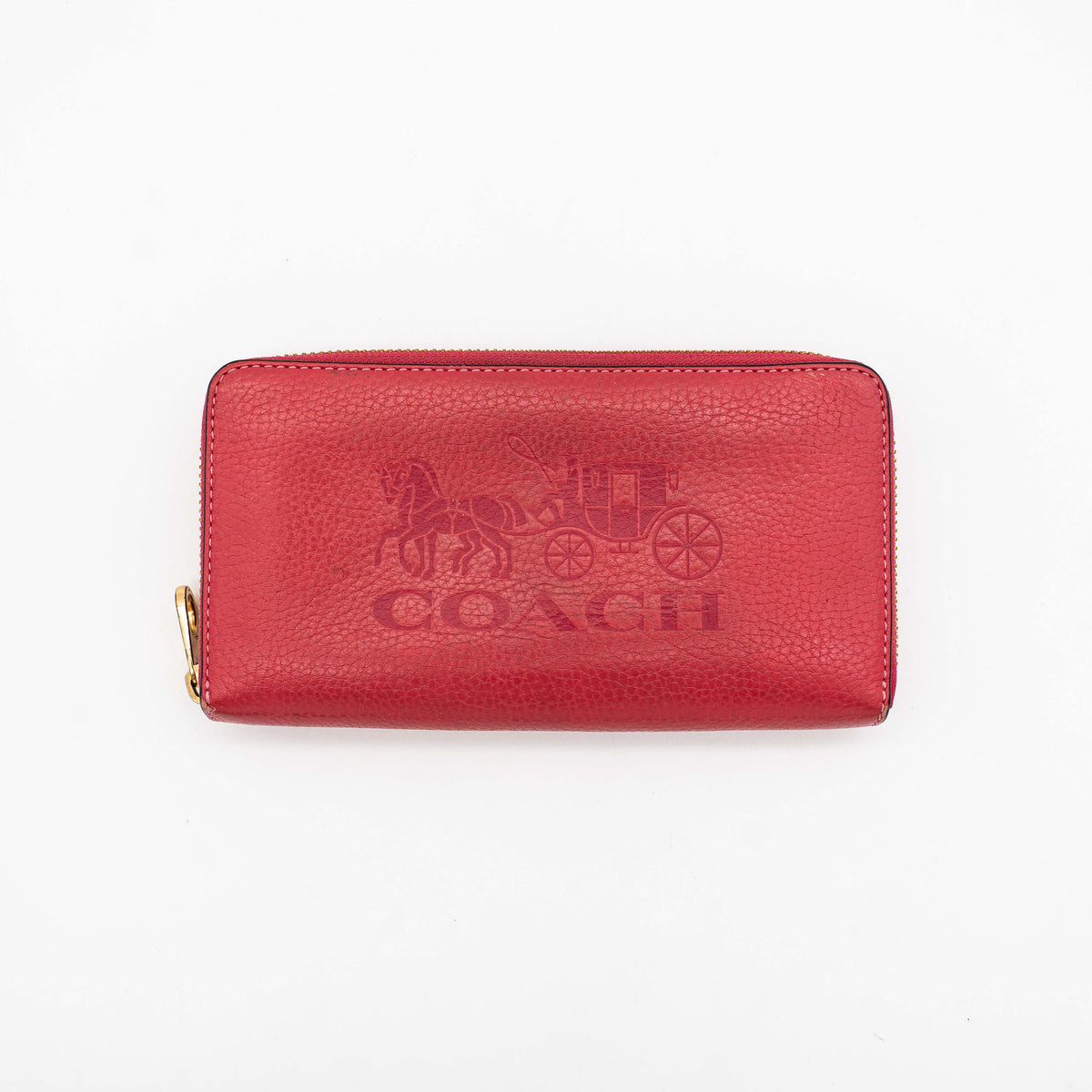 Coach Horse And Carriage Long Zip Around Wallet in red grained leather with gold-tone hardware and embossed logo, shown against a white background.