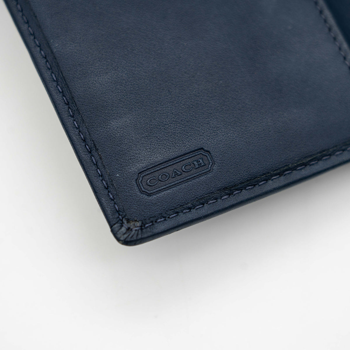 Coach Signature Ashley compact wallet in blue jacquard with leather trim, featuring a silver logo and organized interior.