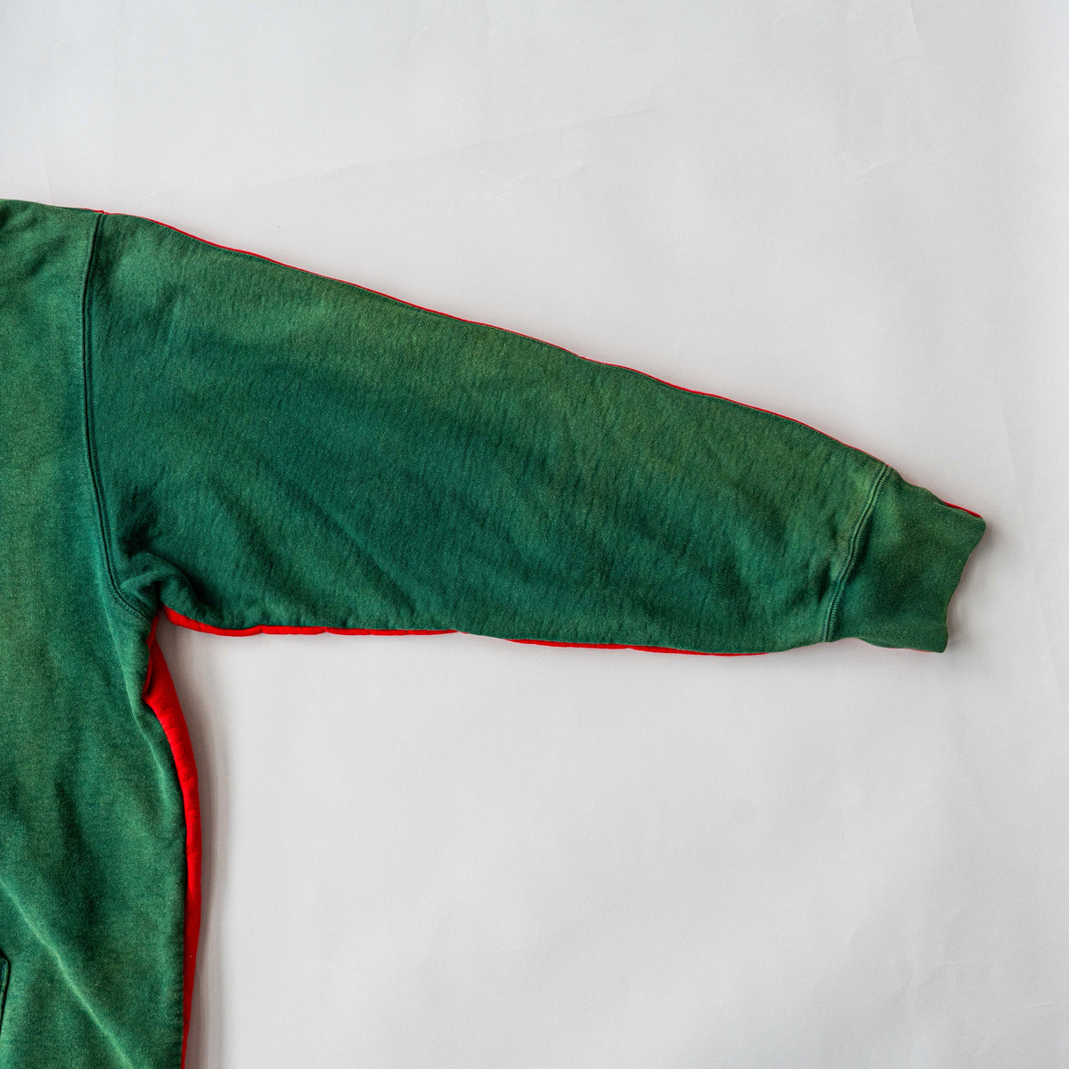 Supreme S Logo Split Hooded Sweatshirt in dark green and red, featuring front 'S' patch and a bold colour contrast.