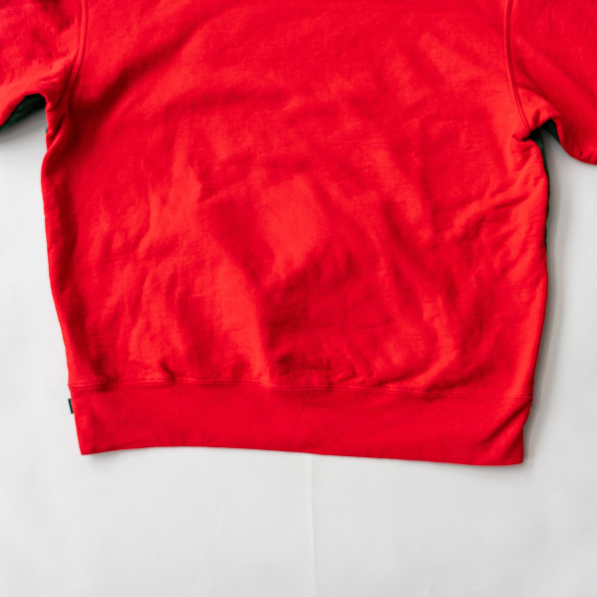 Supreme S Logo Split Hooded Sweatshirt in dark green and red, featuring front 'S' patch and a bold colour contrast.