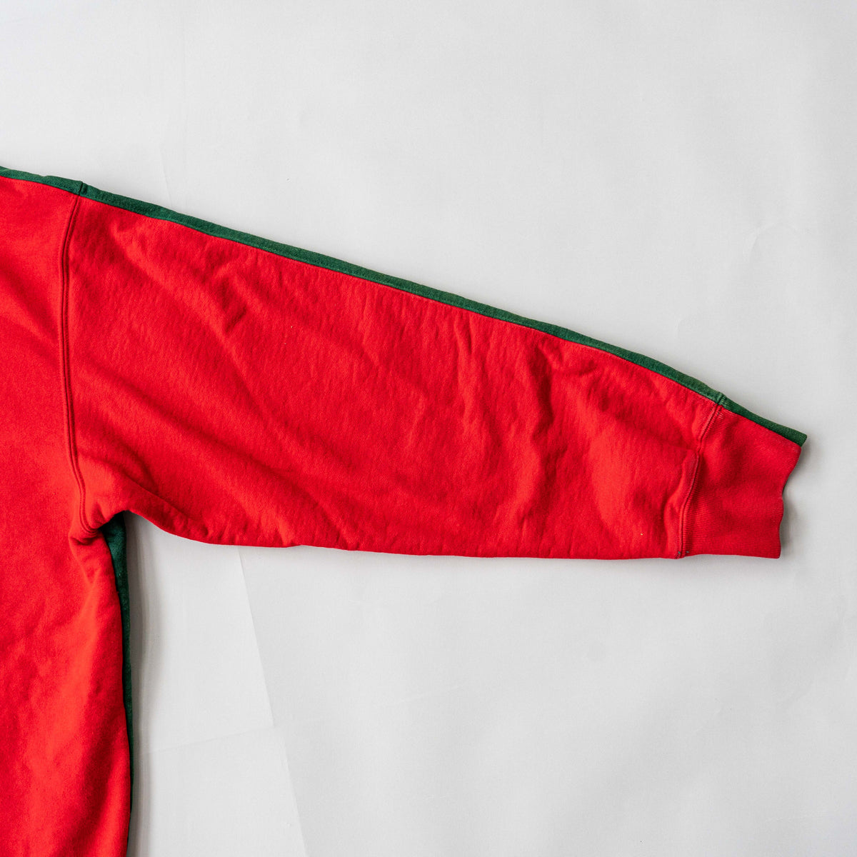 Supreme S Logo Split Hooded Sweatshirt in dark green and red, featuring front 'S' patch and a bold colour contrast.
