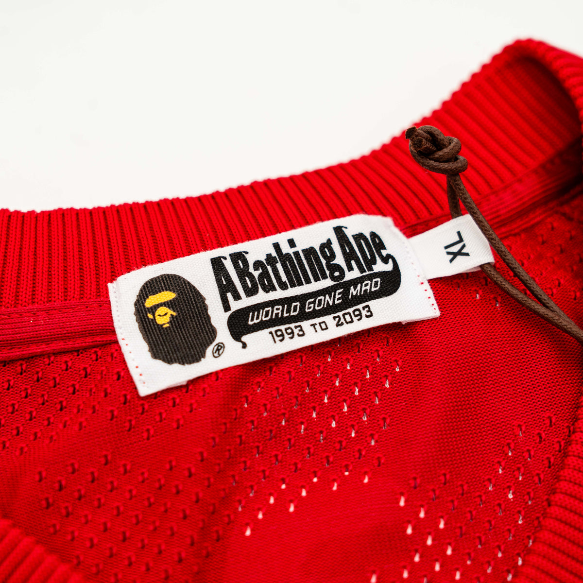 Front view of BAPE Solid Camo Jacquard Mesh Cropped Fit Football Jersey in red and white with bold '93' print and original tags.