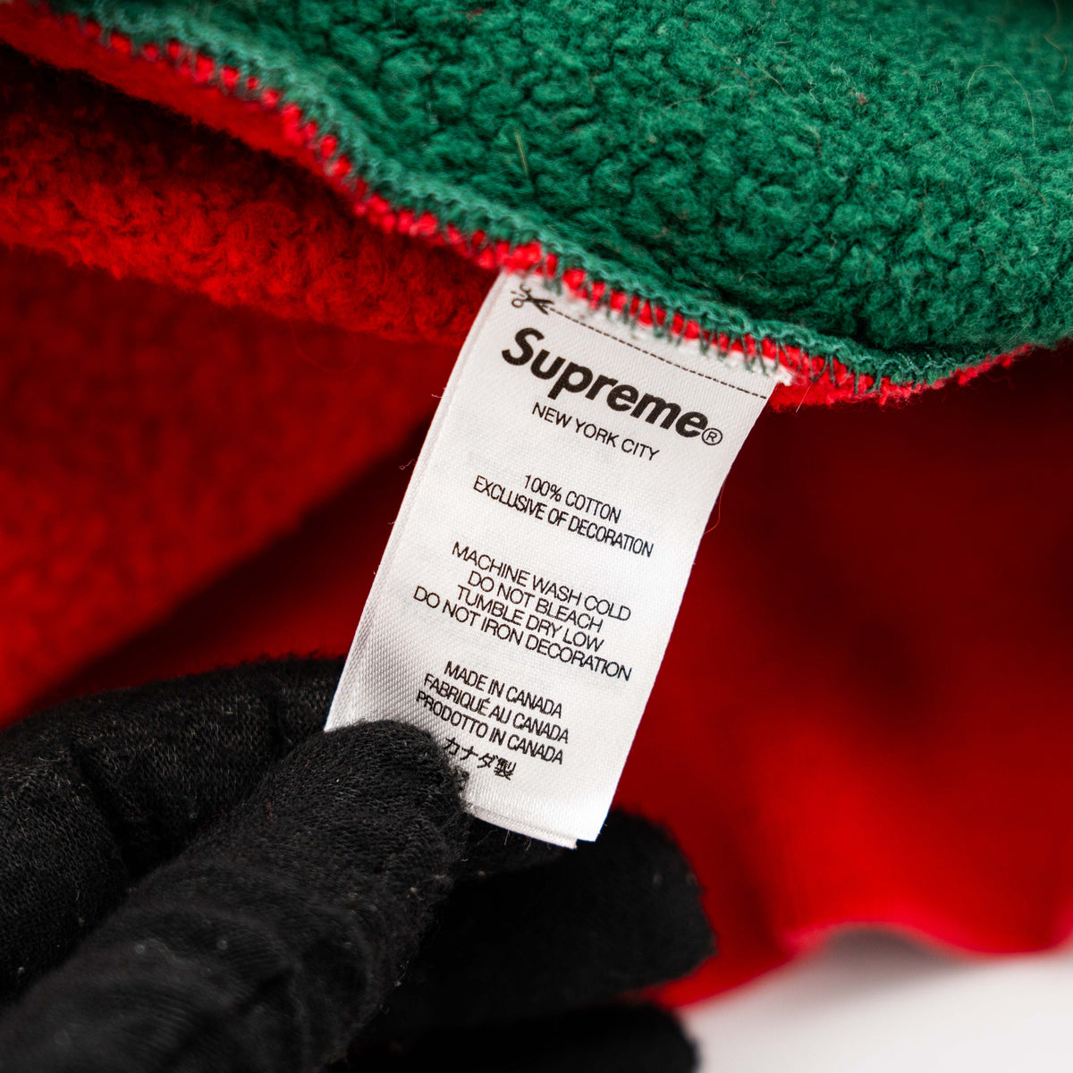 Supreme S Logo Split Hooded Sweatshirt in dark green and red, featuring front 'S' patch and a bold colour contrast.