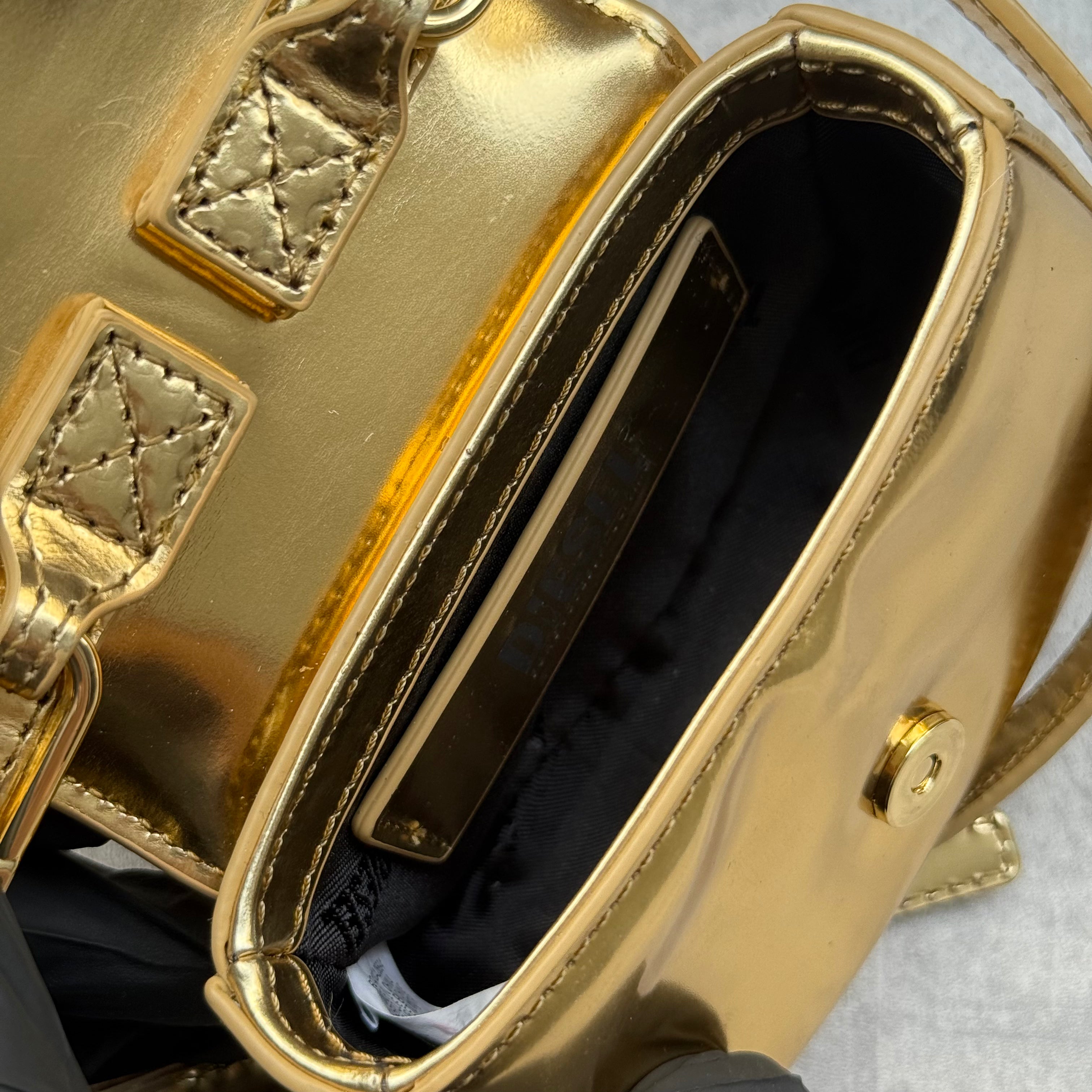 Diesel 1DR-XS-S Mini Bag in metallic gold with signature D logo plaque, detachable strap, and structured silhouette