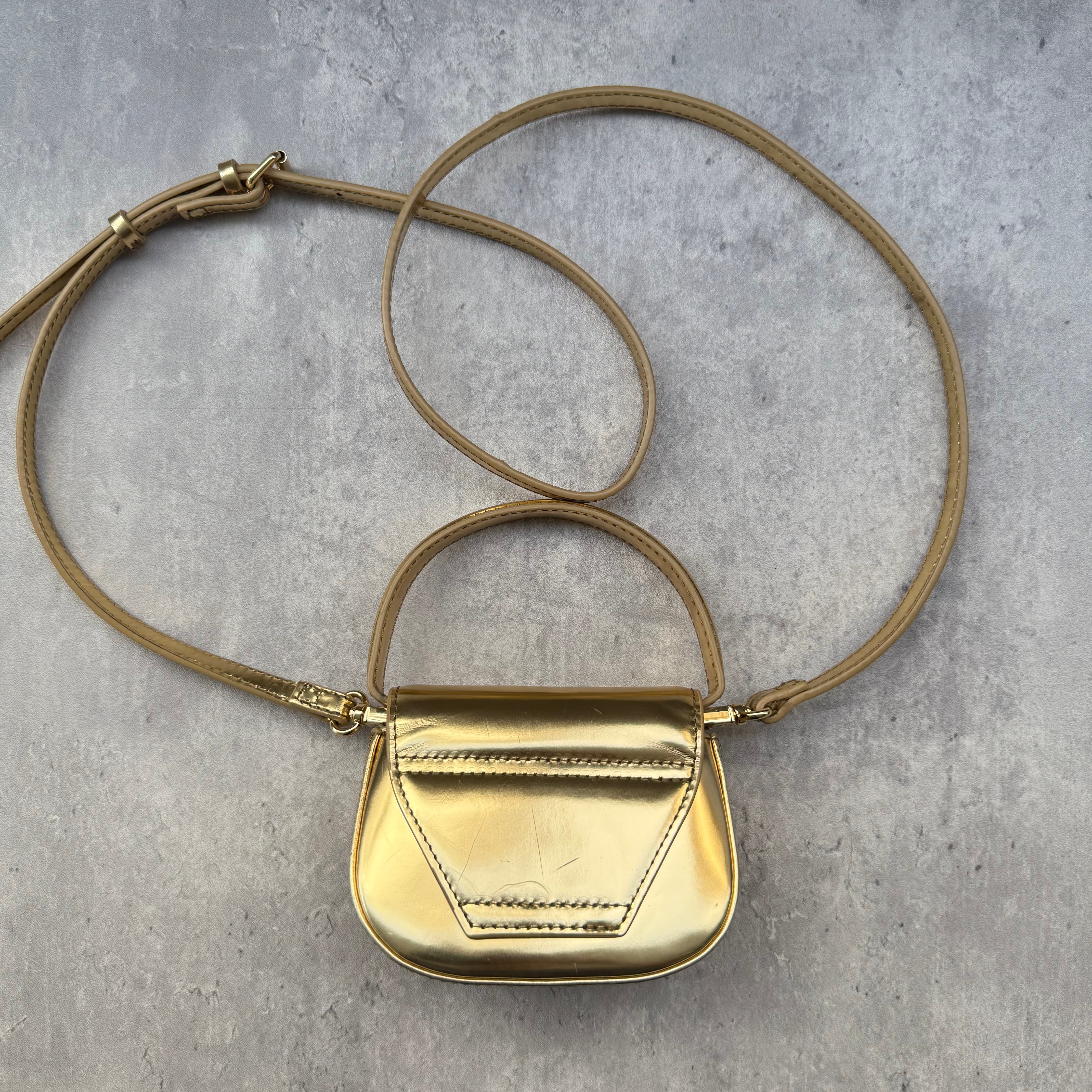 Diesel 1DR-XS-S Mini Bag in metallic gold with signature D logo plaque, detachable strap, and structured silhouette