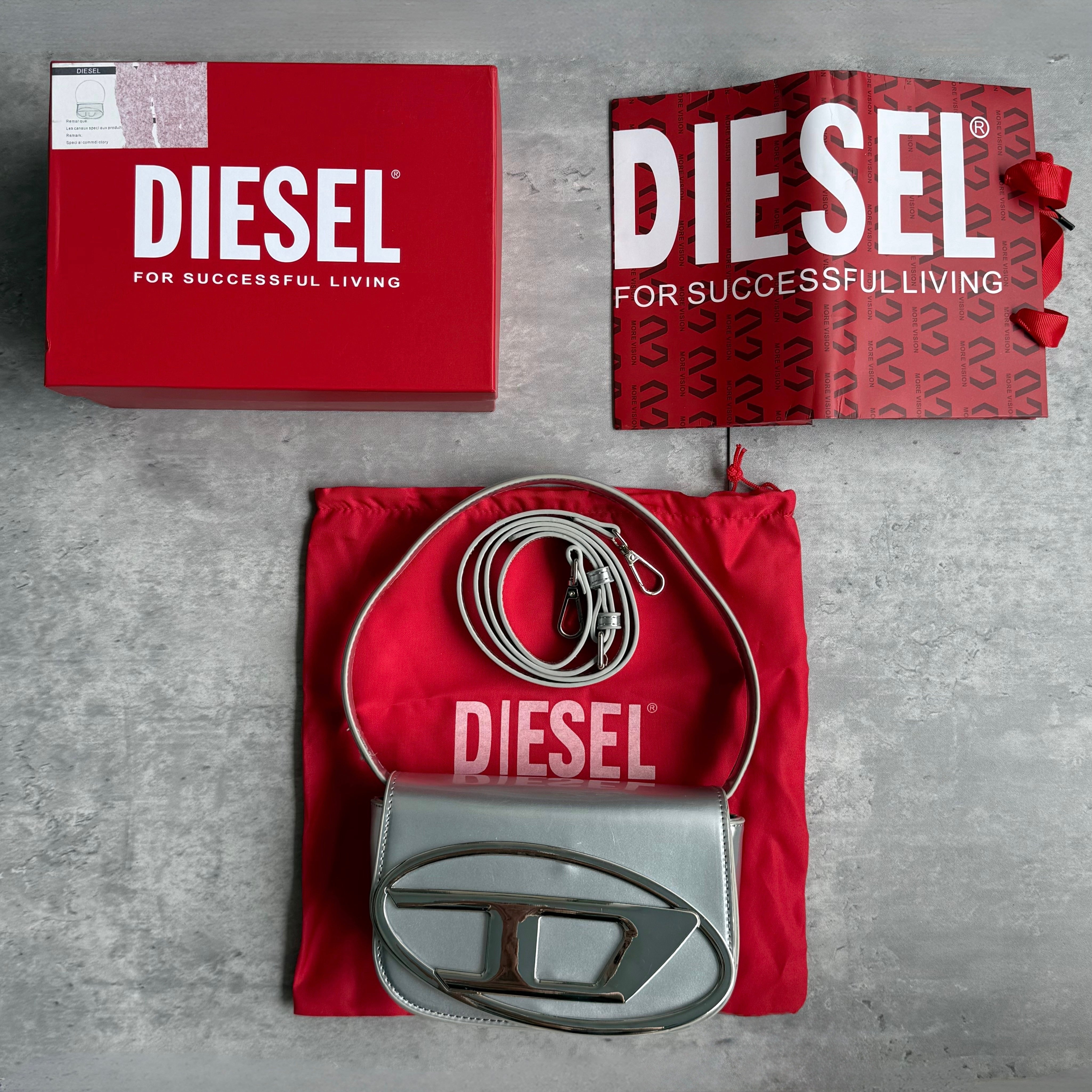 Diesel 1DR Shoulder Bag in metallic and matte silver with oversized D logo plaque and single strap.