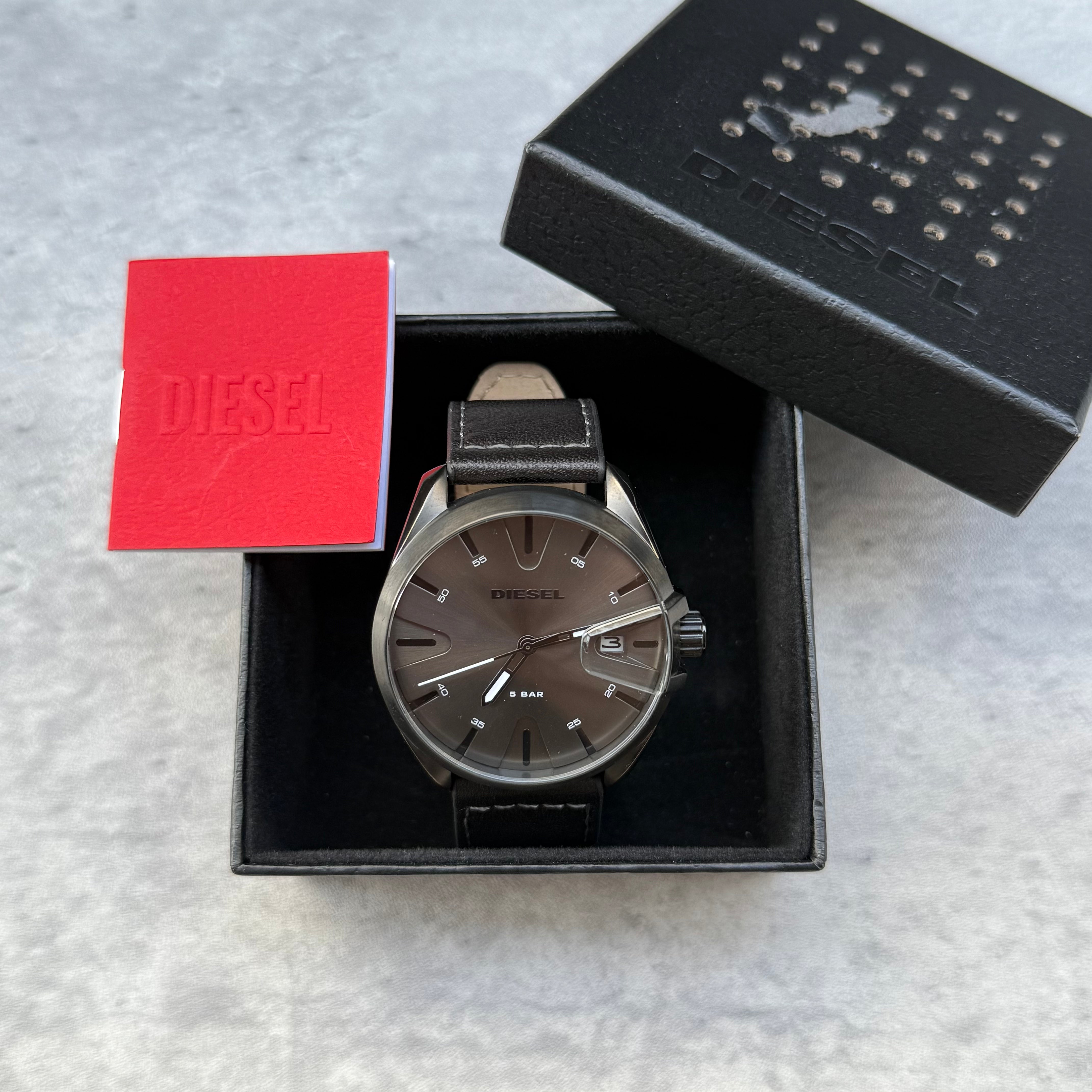 Pre-loved Diesel DZ1924 MS9 three-hand black leather watch with silver-tone dial, shown with original box and booklet
