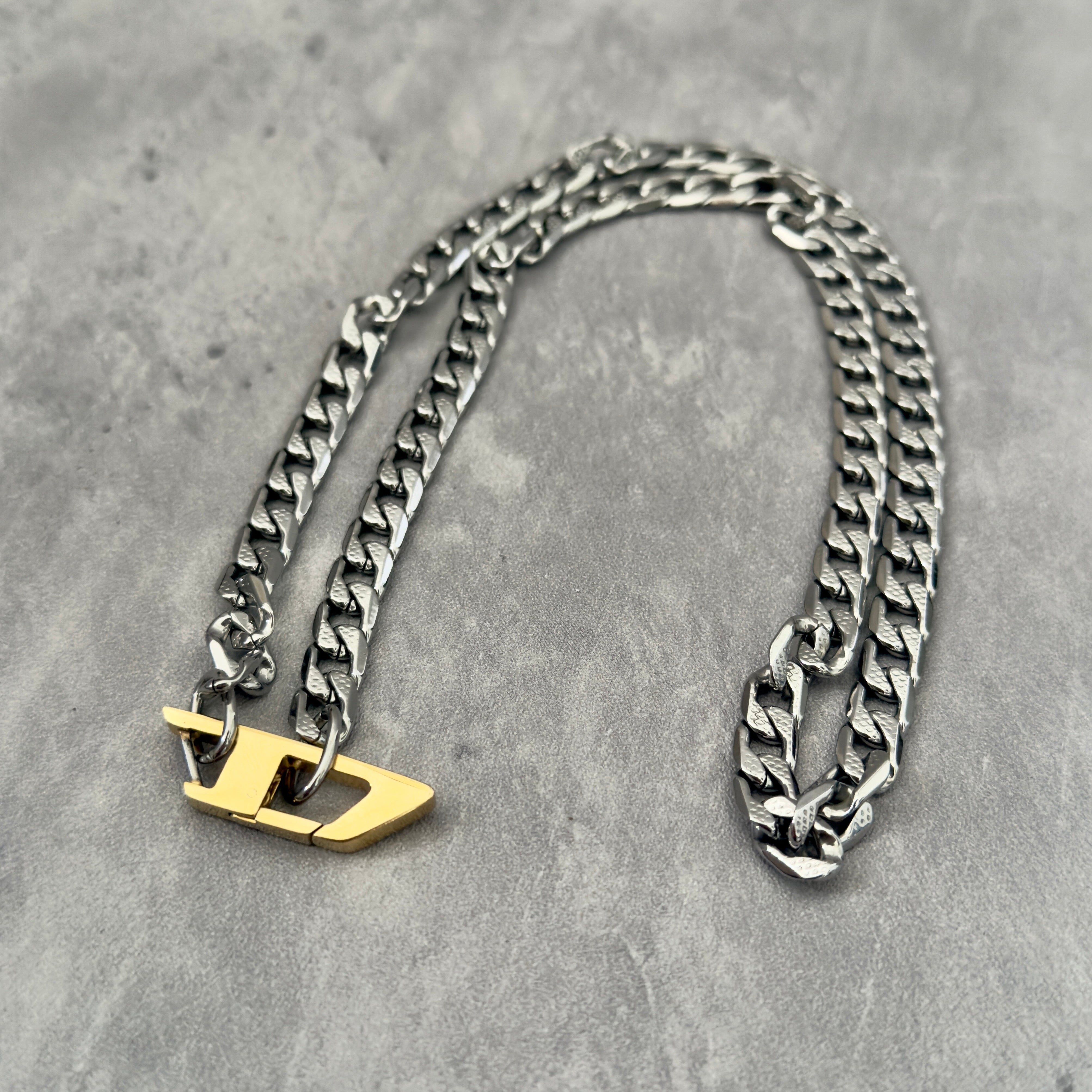Diesel Signature Gold D-Logo Stainless Steel Necklace, featuring a silver-tone chunky chain with a gold-tone Diesel "D" logo pendant.