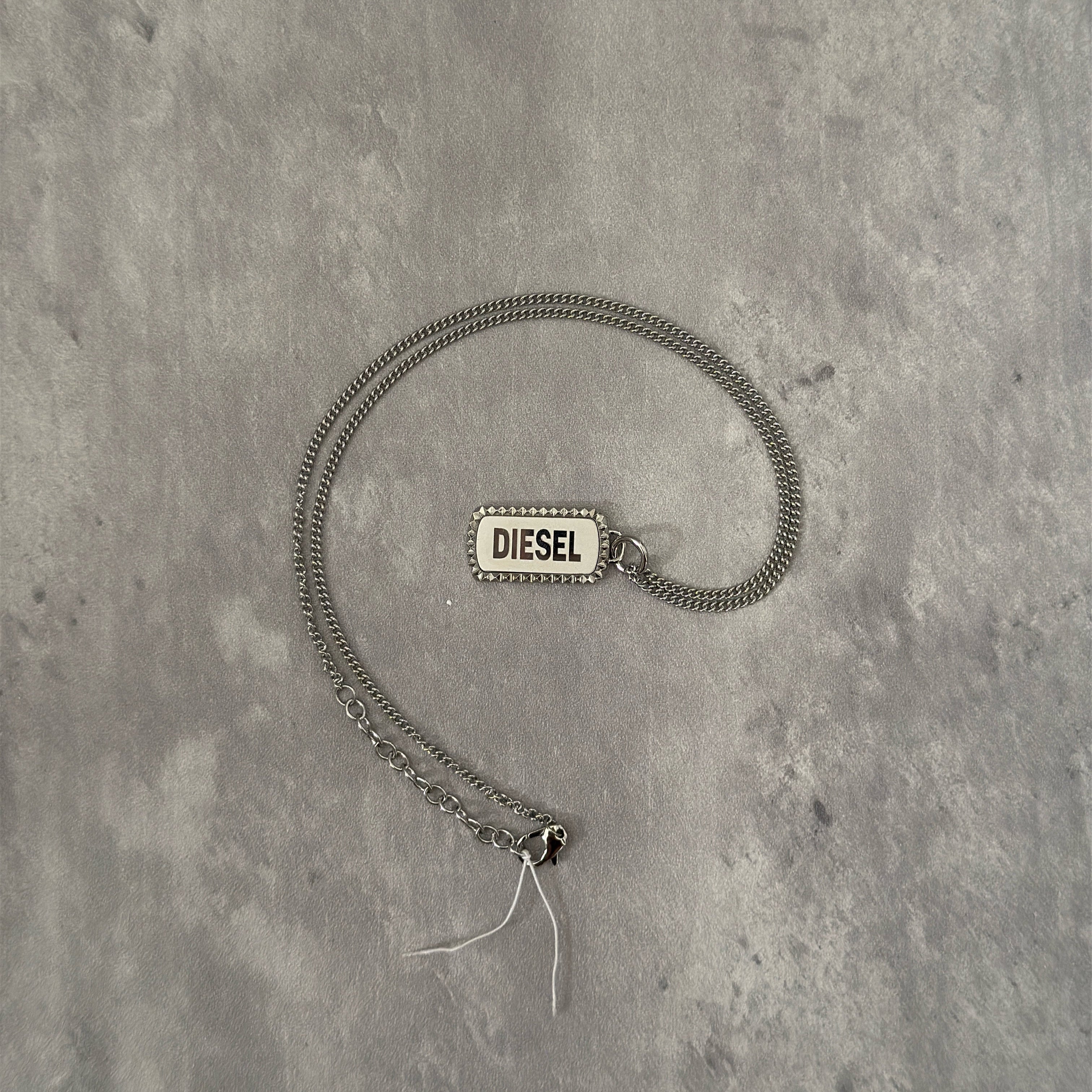 Diesel Signature Stainless Steel Dog Tag Necklace with a studded border and logo engraving on a silver-tone chain.
