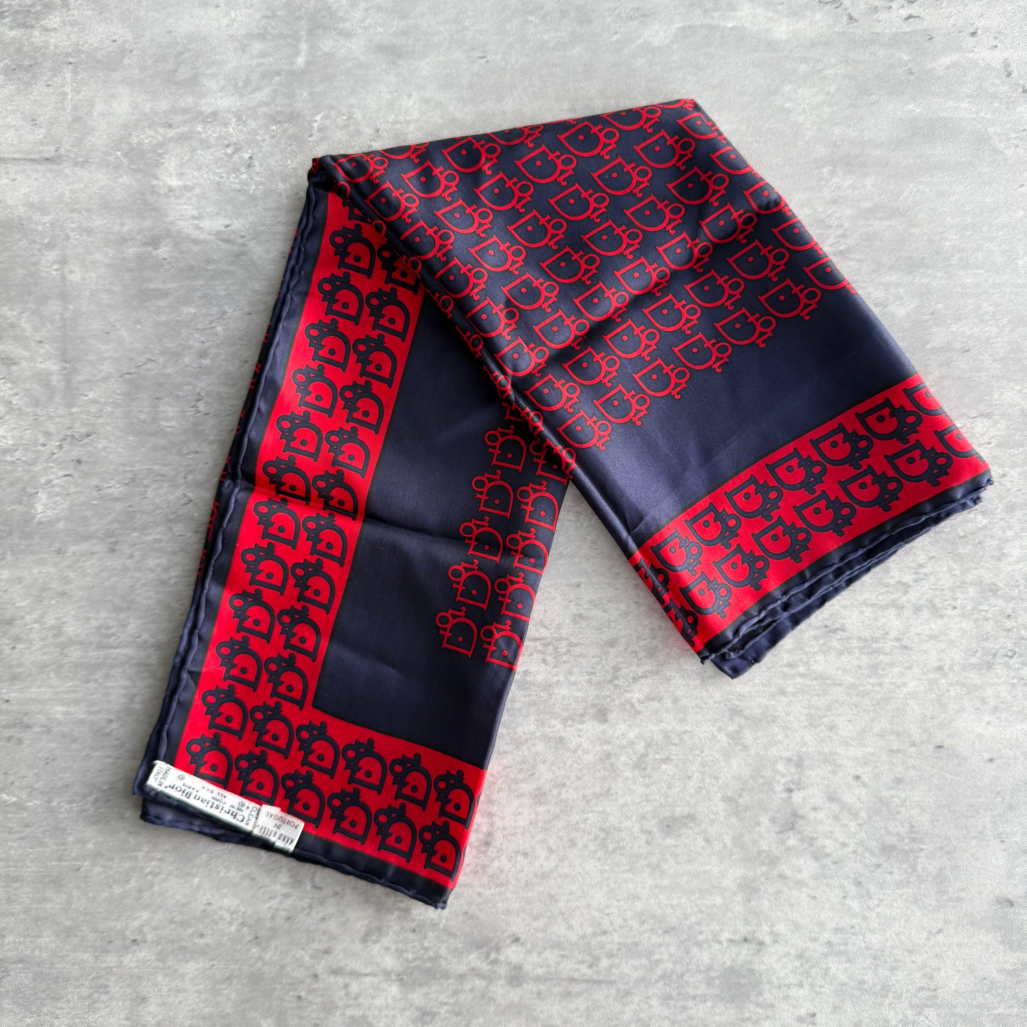 Dior Monogram Logo Silk Scarf in red and navy with all-over logo pattern and hand-rolled edges.