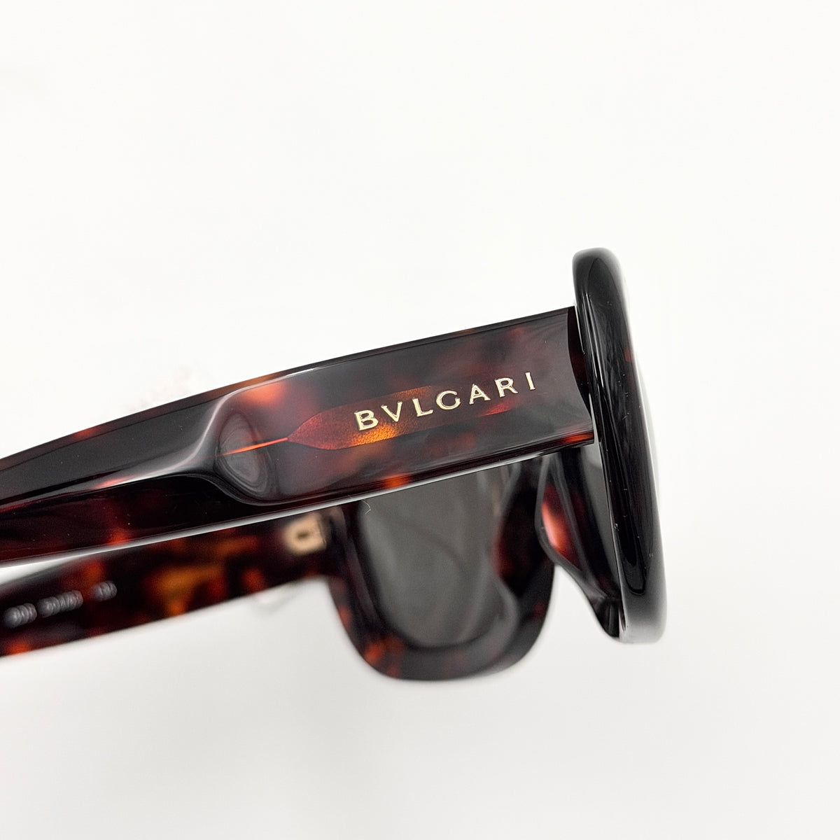 Bvlgari 808 sunglasses in tortoiseshell brown acetate displayed with original case and cloth.