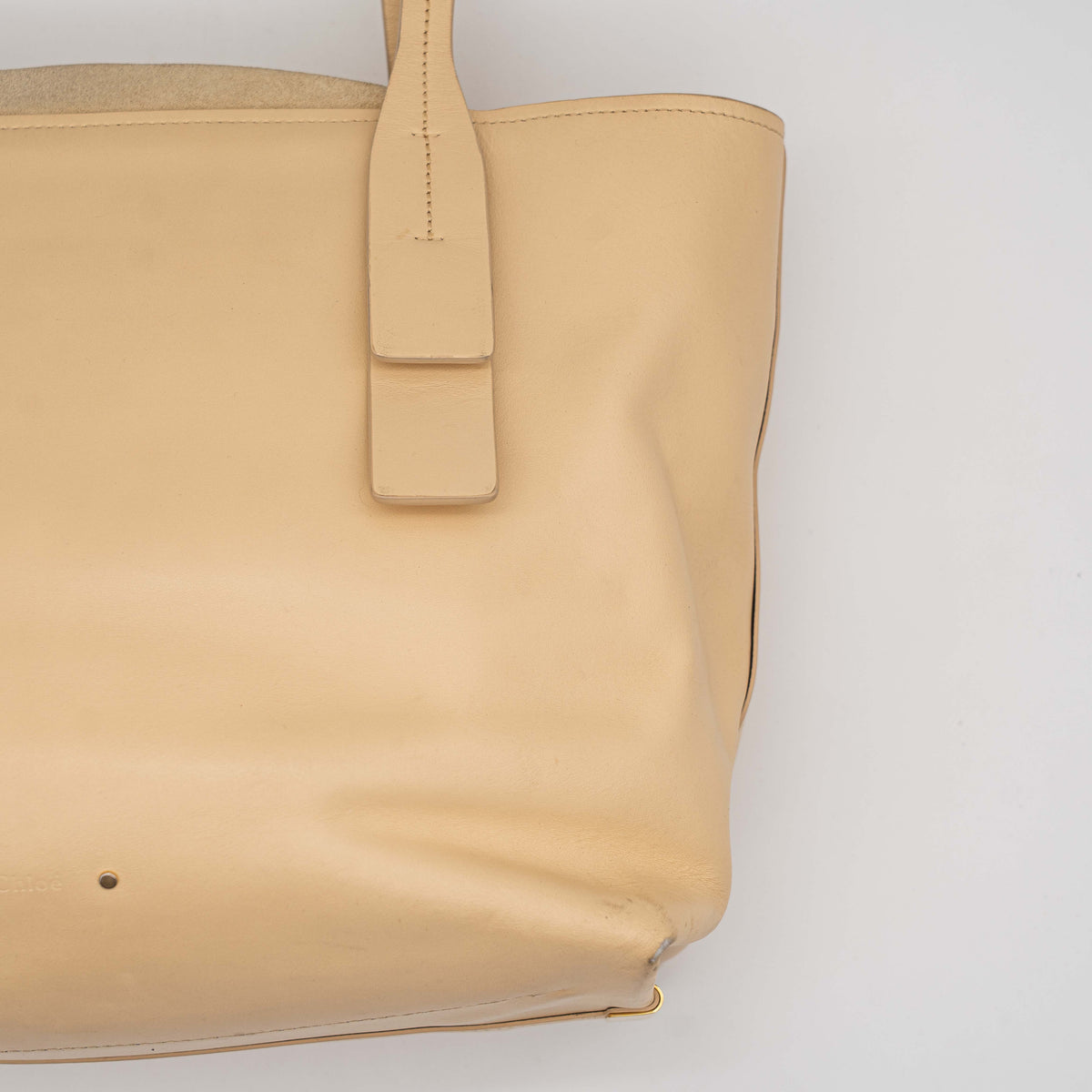 Chloé C Zipped Tote Bag in beige leather with gold hardware, shown with structured dual straps and front logo detail.