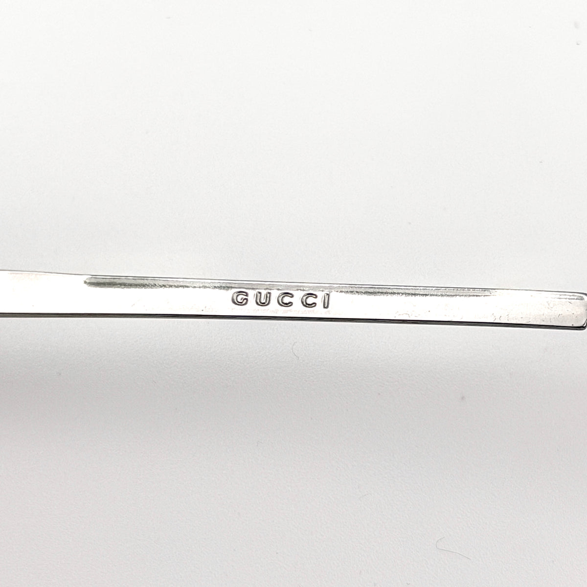 Gucci GG2689/S rectangle sunglasses in silver with pink gradient lenses, shown with case and cloth.