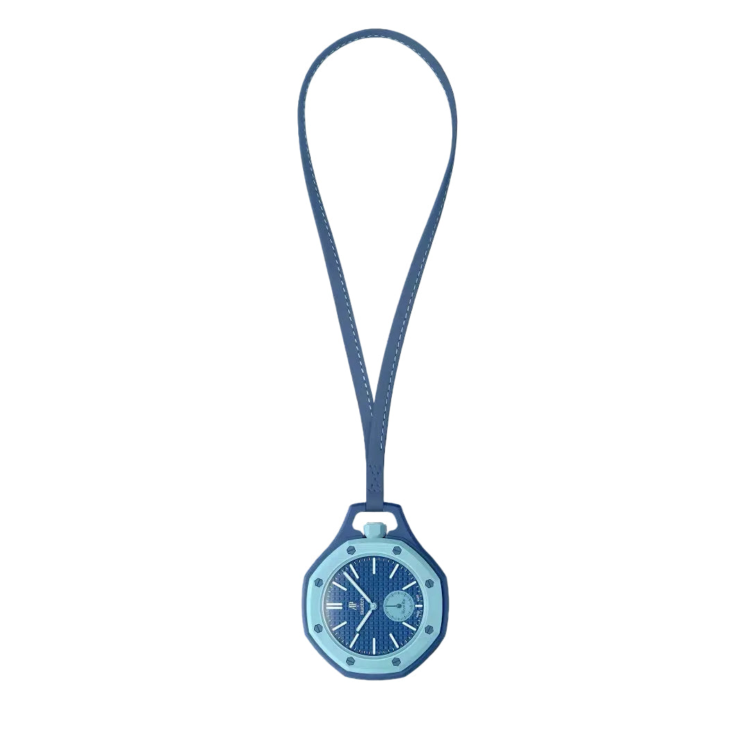 A Swatch x Audemars Piguet Royal Pop Lan Ba pendant watch in blue, featuring a geometric case, textured dial, and stitched blue strap.