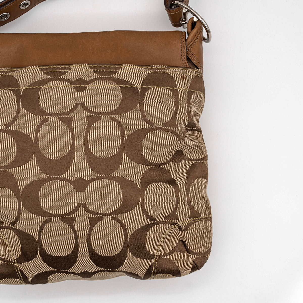 Coach 2Way Signature Soho Buckle Flap Shoulder Bag in beige and tan with silver buckle and adjustable leather strap, shown on a white background.