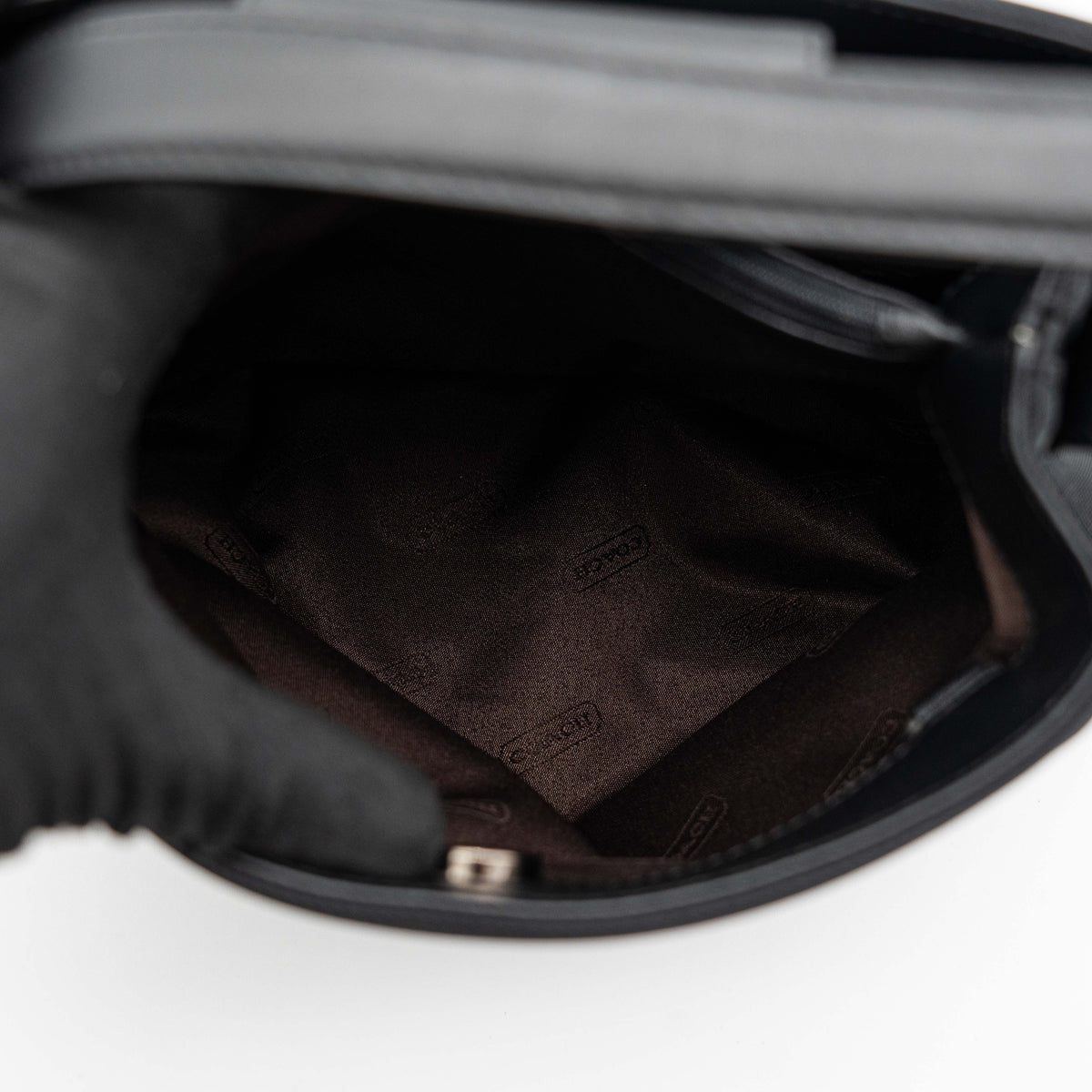 Coach Mercer tote bag in black nylon with leather handle and trim, presented against a white background.