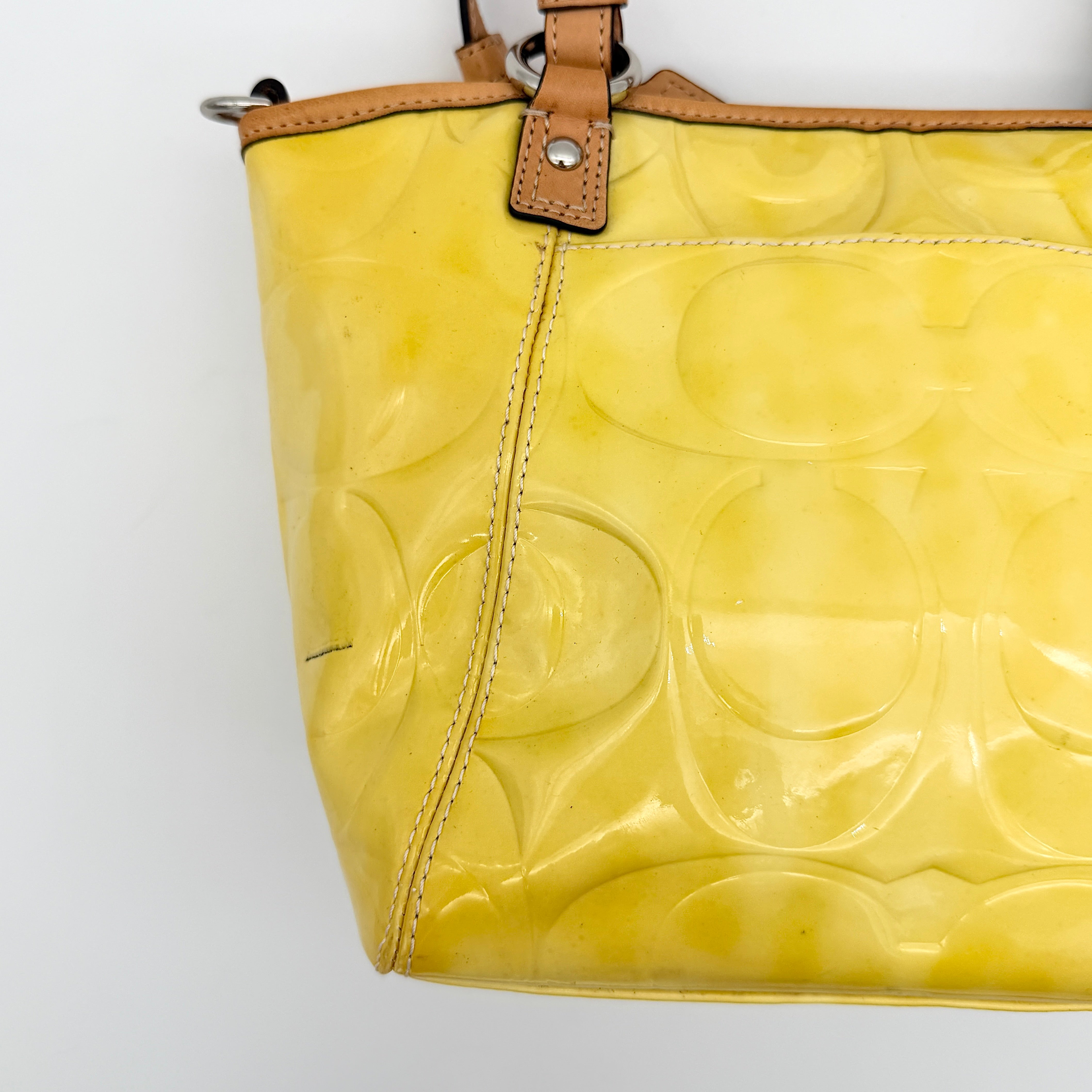 Coach Peyton tote in glossy yellow patent leather with tan handles and detachable strap, shown with blush pink interior.