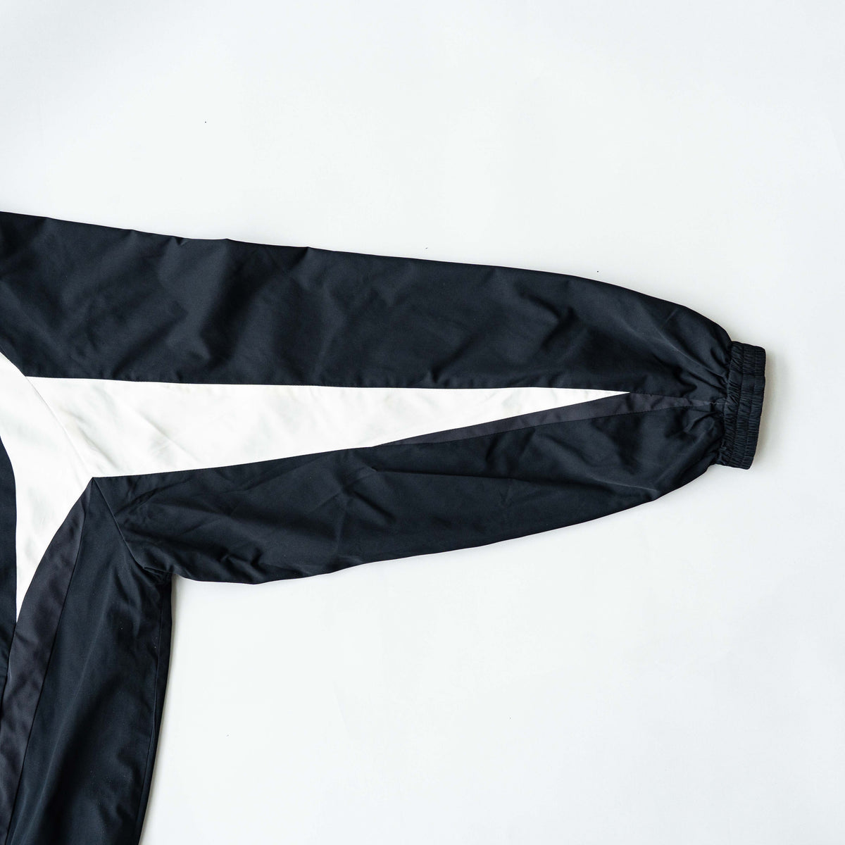 BAPE A Bathing Ape black and white logo track jacket with bold panel detailing, shown laid flat.