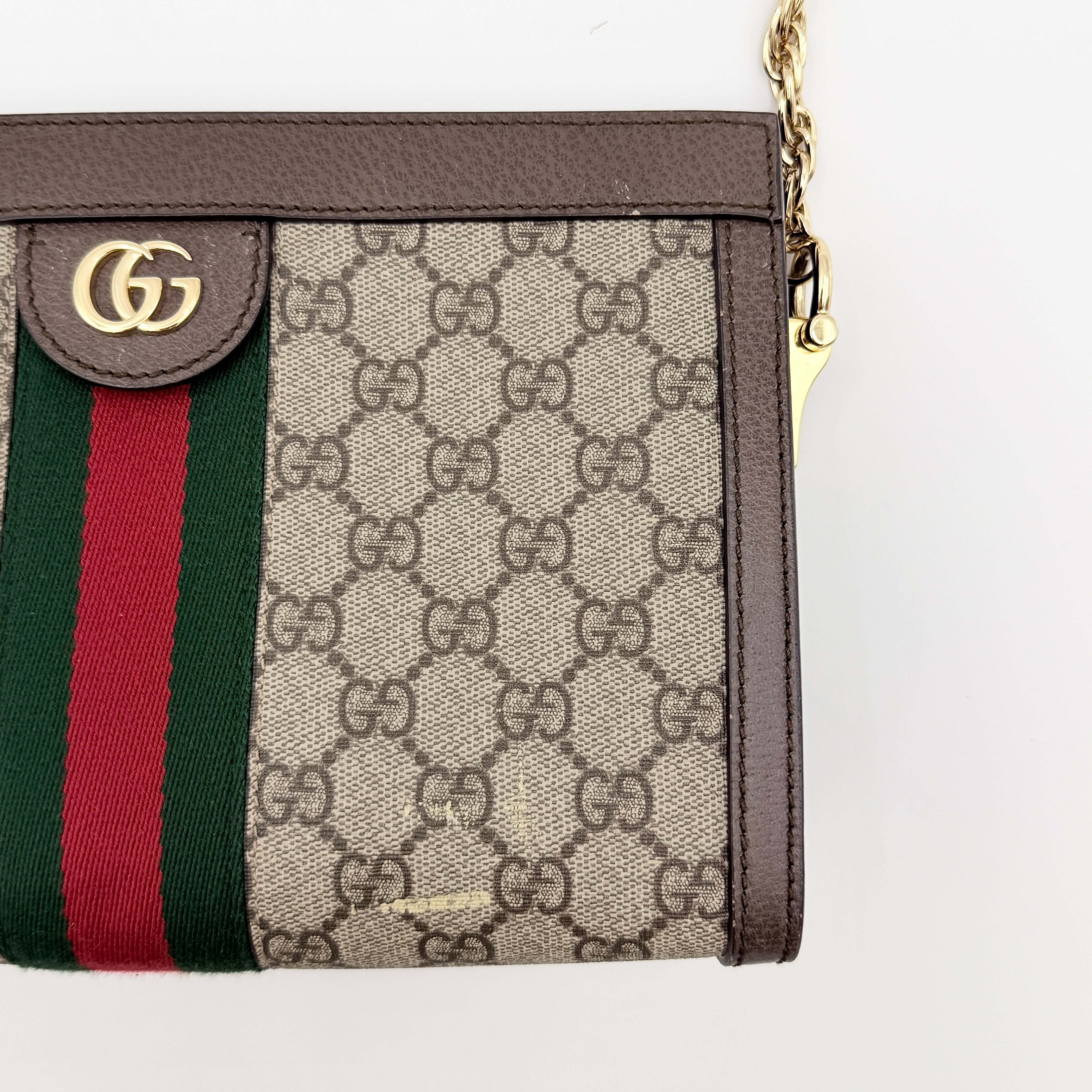 Gucci Ophidia GG Supreme crossbody bag in beige canvas with brown leather trim, signature web stripe, and gold chain strap.