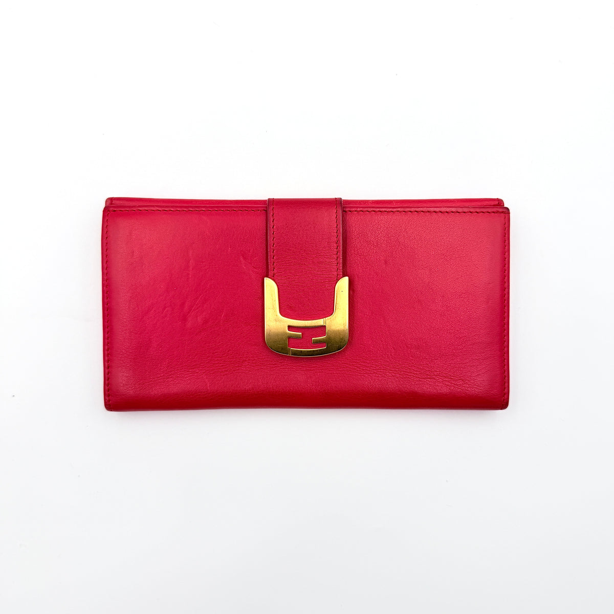 Fendi FF Logo Buckle Flap Continental Wallet in red leather with gold hardware, displayed closed on a white background.