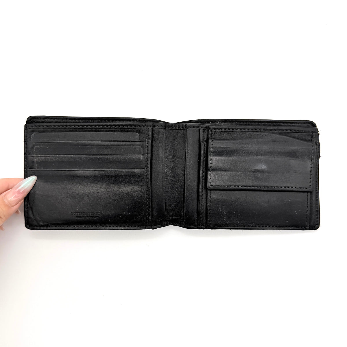 Bottega Veneta black Intrecciato woven leather wallet, shown closed against a white background.