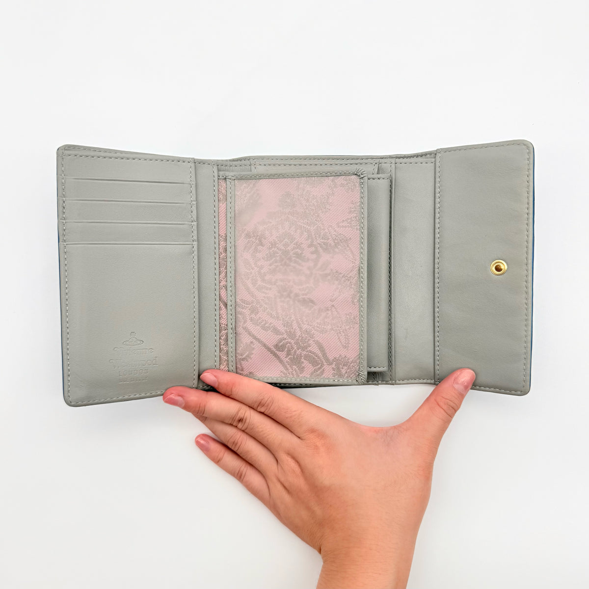 Vivienne Westwood blue leather trifold wallet with gold Orb emblem, shown with original box and documents.