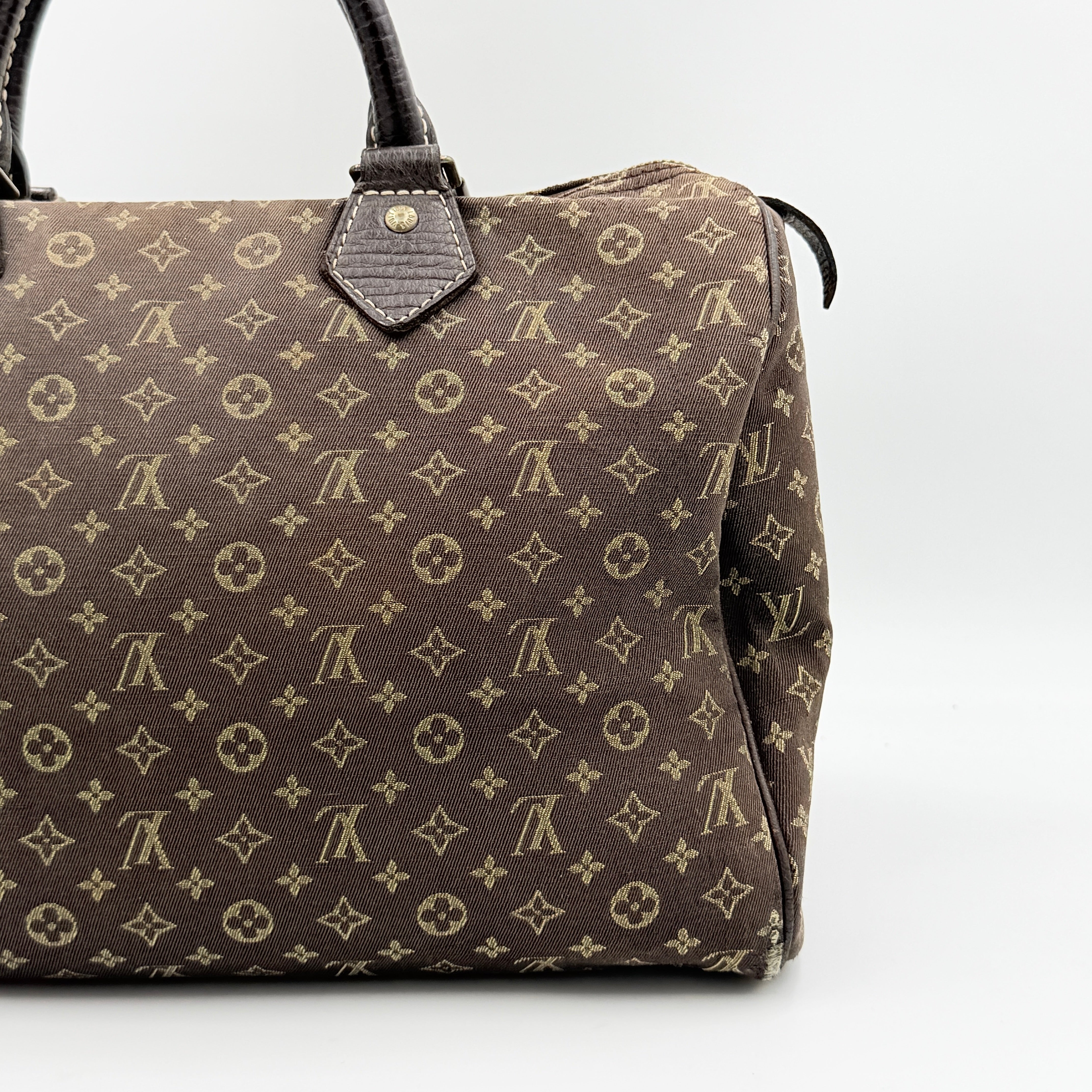 Louis Vuitton Monogram Mini Lin Speedy 30 in brown textile with top handles and monogram motif, shown against a white background.