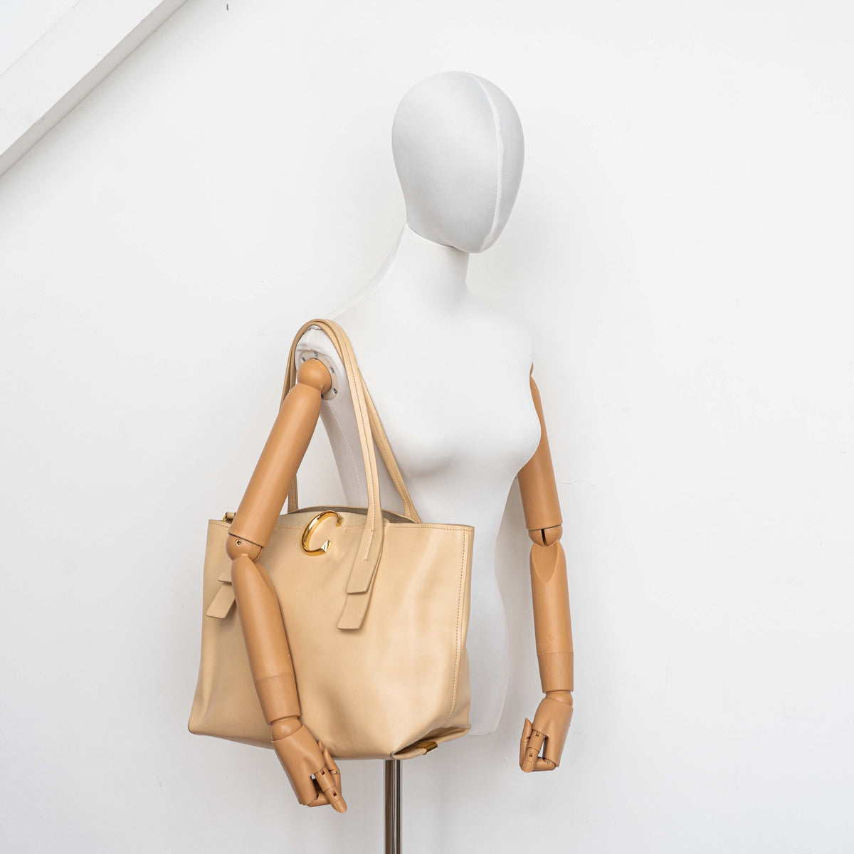 Chloé C Zipped Tote Bag in beige leather with gold hardware, shown with structured dual straps and front logo detail.