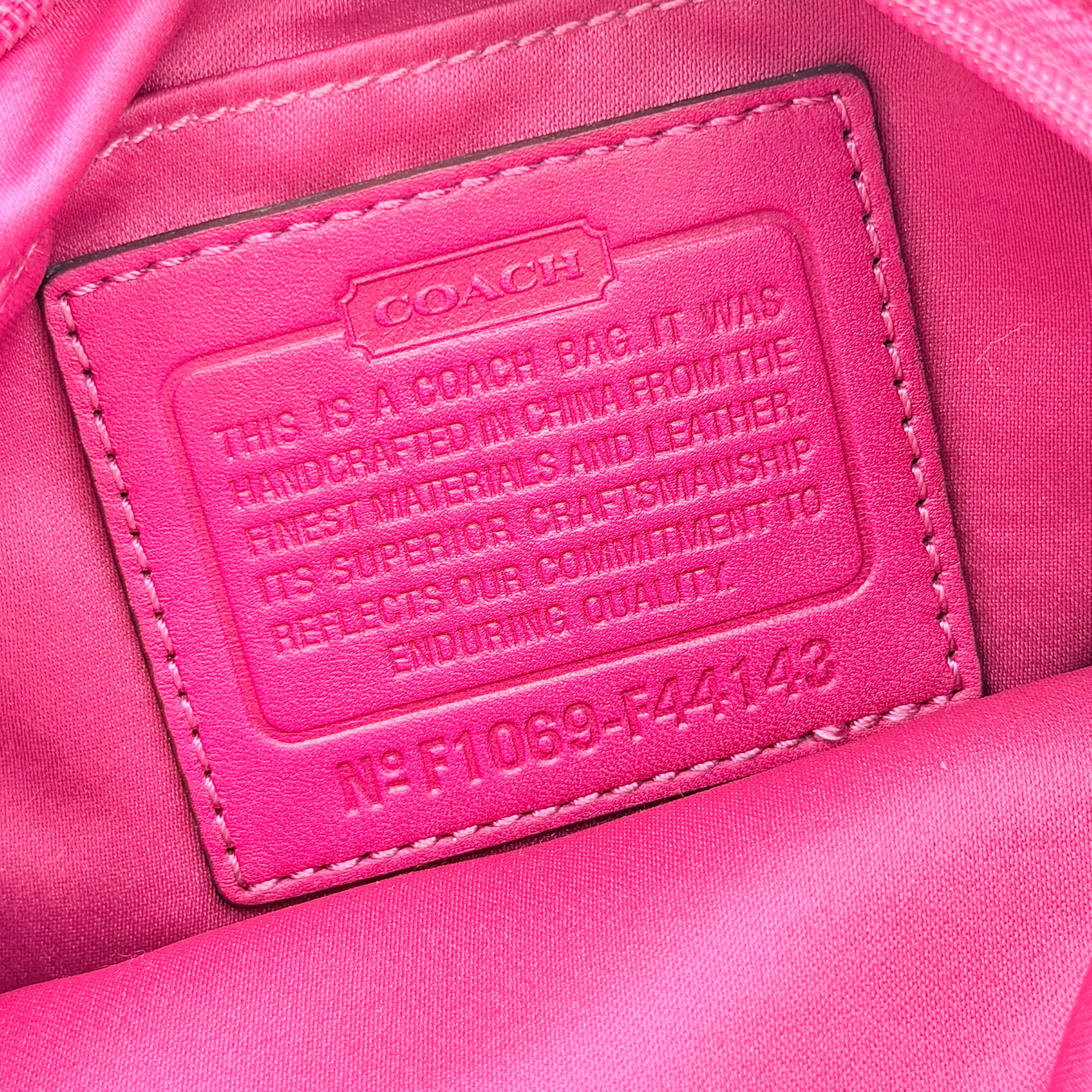 Coach Carly Hobo Shoulder Bag in vivid pink jacquard and leather, featuring signature chain detail and silver hardware.