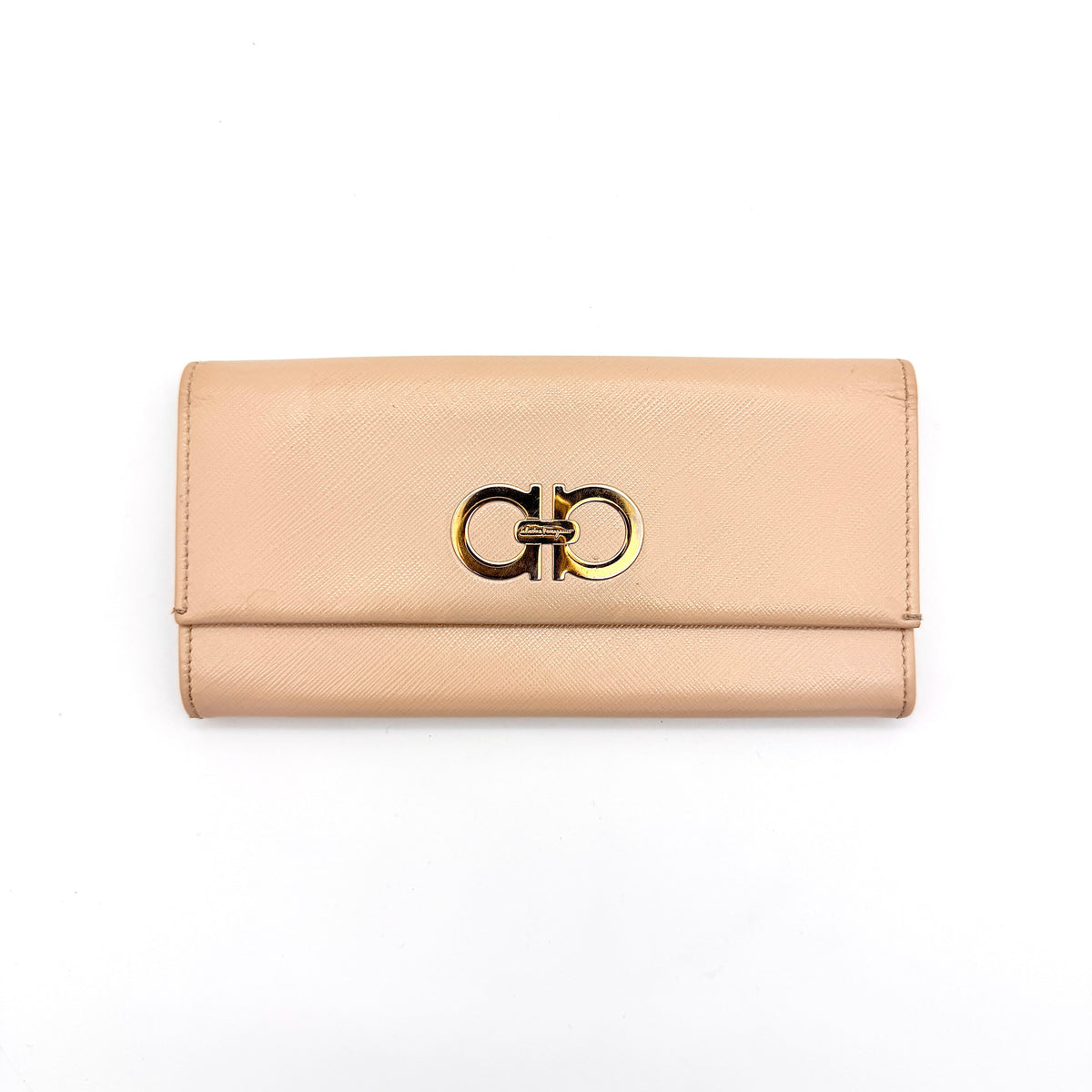Salvatore Ferragamo light pink Saffiano wallet with gold Gancini hardware, shown on a white background.