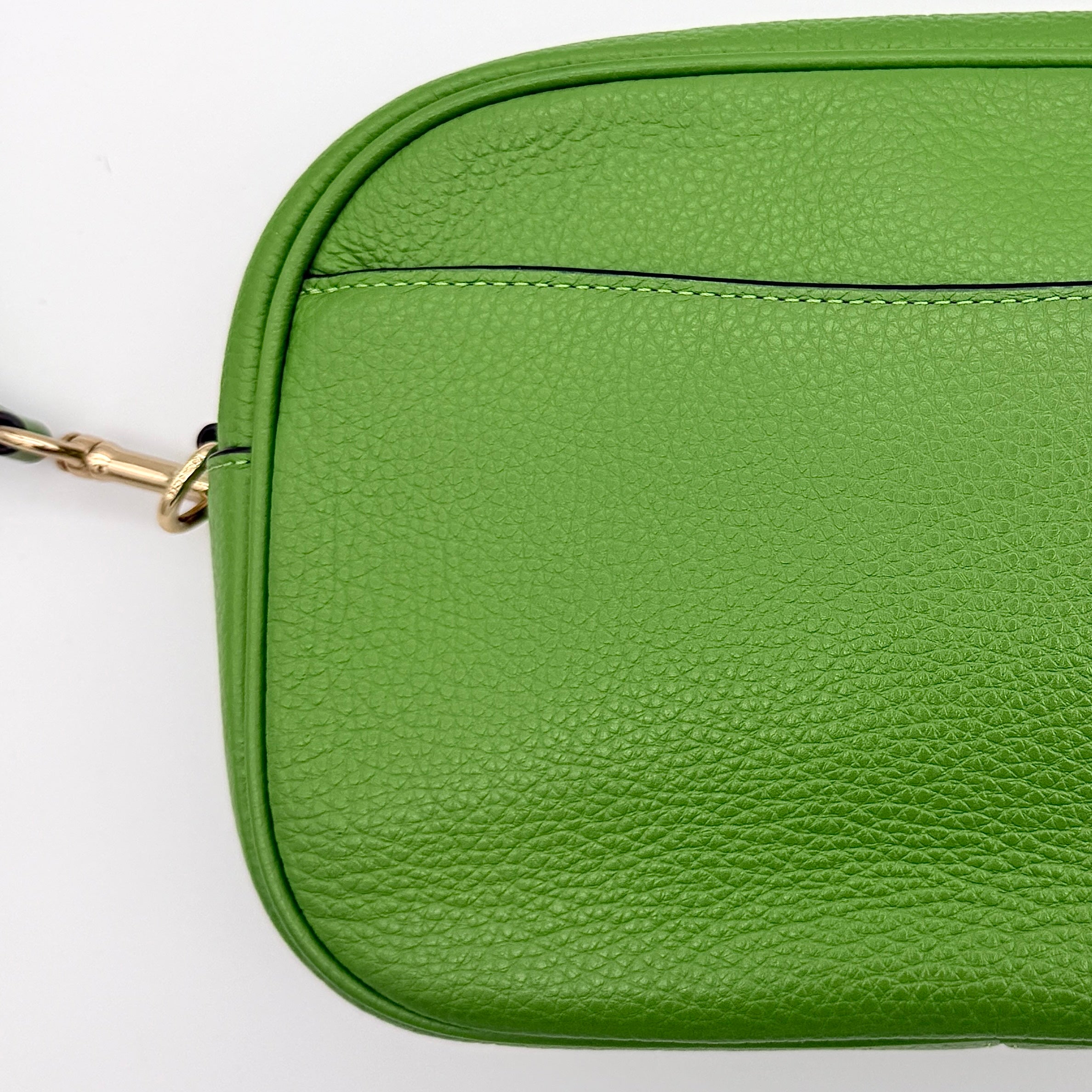 Coach Jamie Camera Crossbody Bag in green textured leather with gold-tone hardware and adjustable strap.