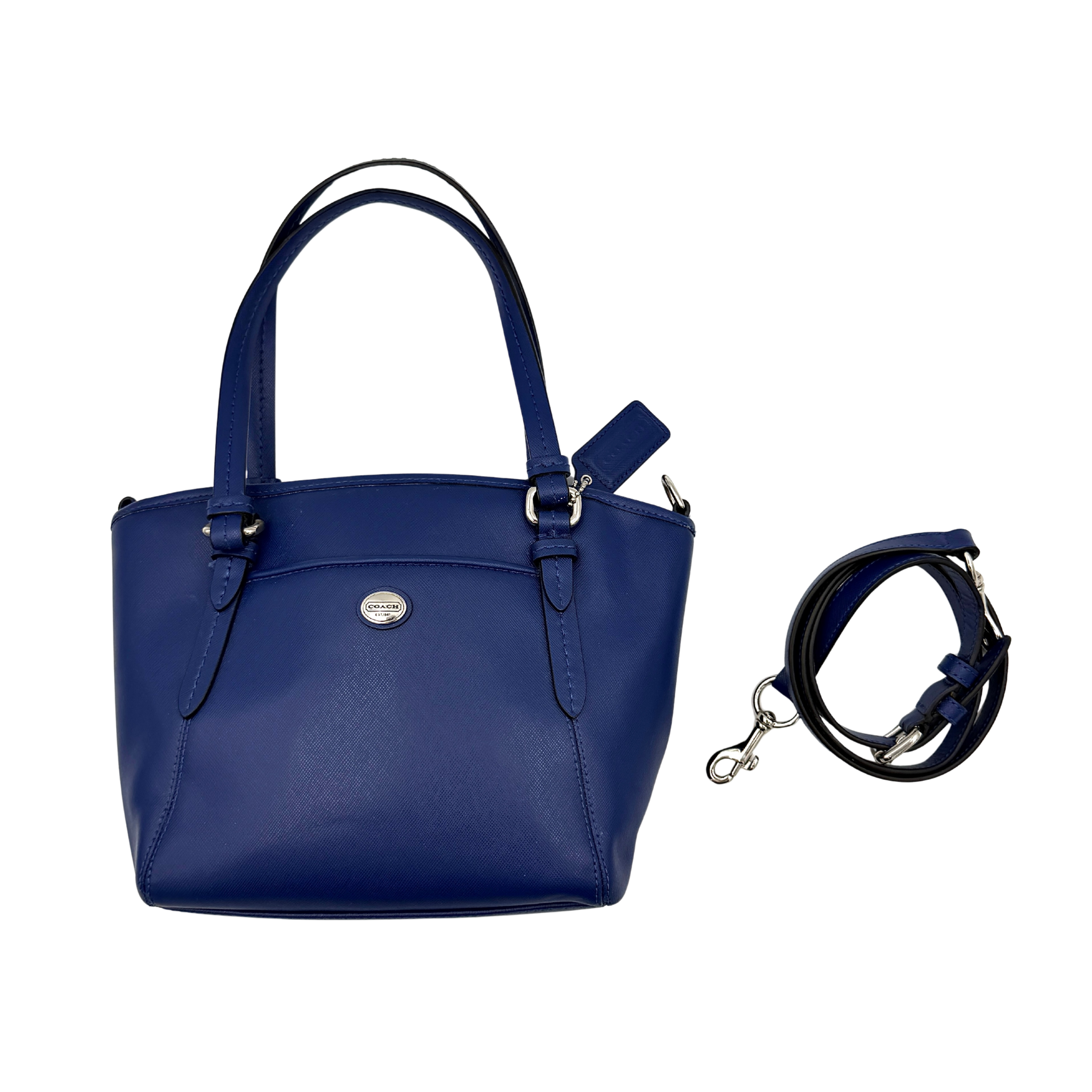 A structured cobalt blue Coach tote bag with silver hardware, dual handles, and an optional crossbody strap, displayed against a clean background.