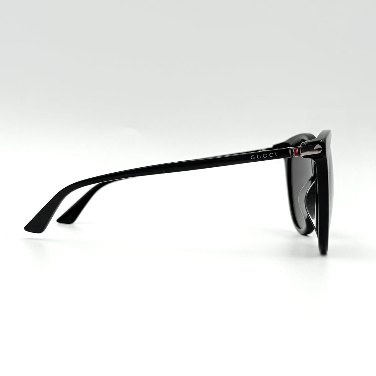 Gucci GG0064SK 001 black round sunglasses with smoky lenses, shown with original burgundy velvet case and pouch.