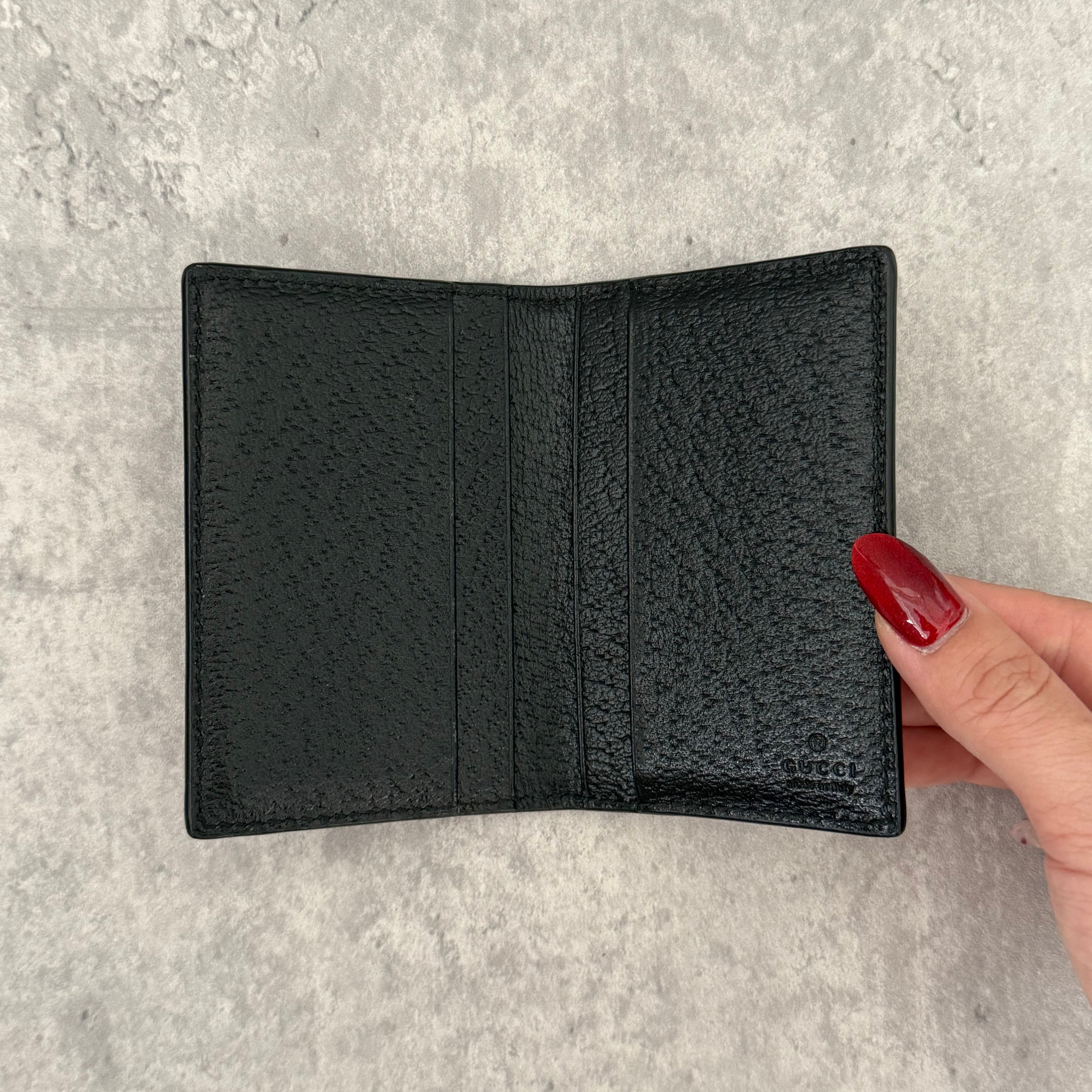 Gucci Interlocking G Black Leather Cardholder, featuring pebbled leather and silver-tone logo hardware in a slim bifold design