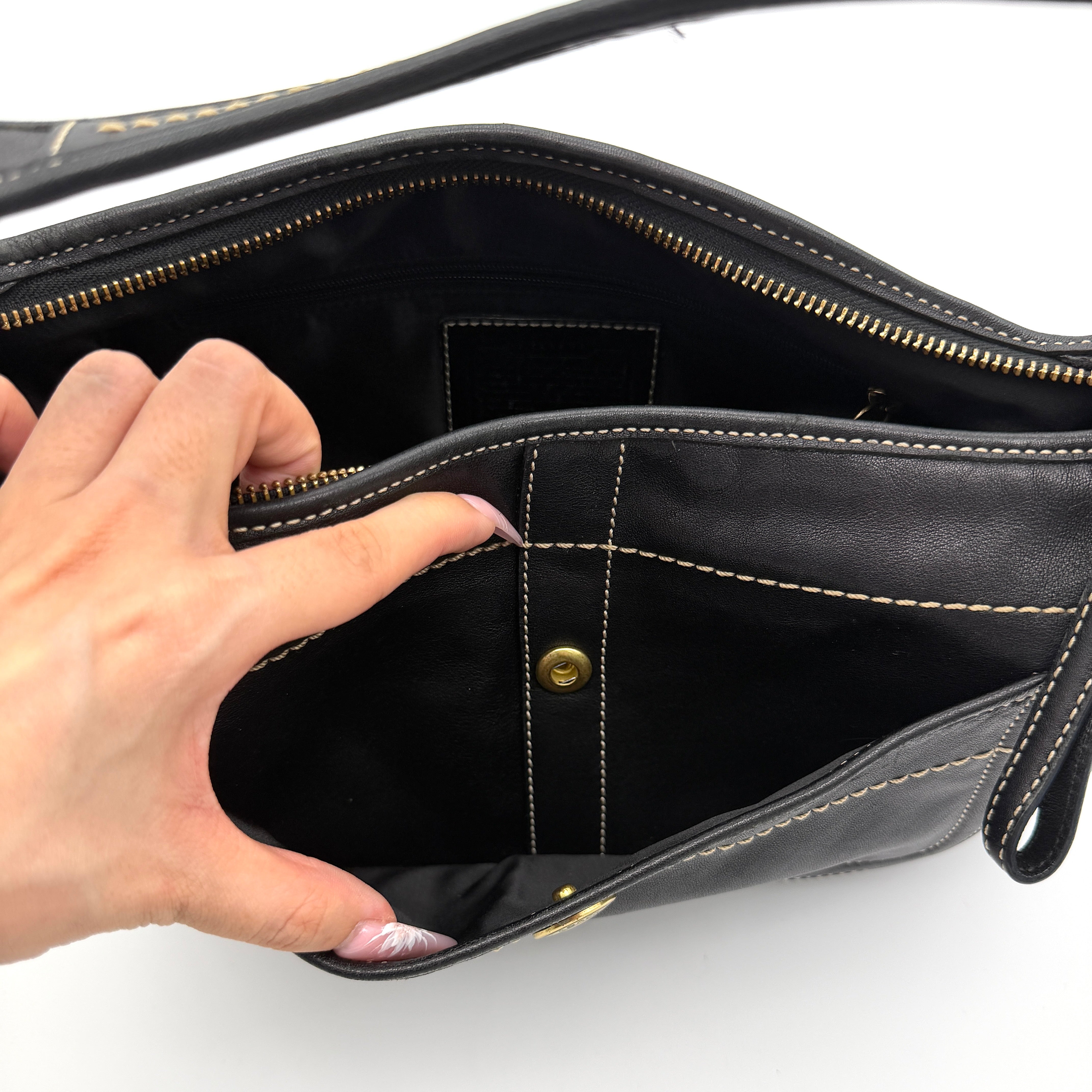 Coach Signature Ergo Hobo Shoulder Bag in black leather with contrast stitching and brass hardware, displayed against a white background.
