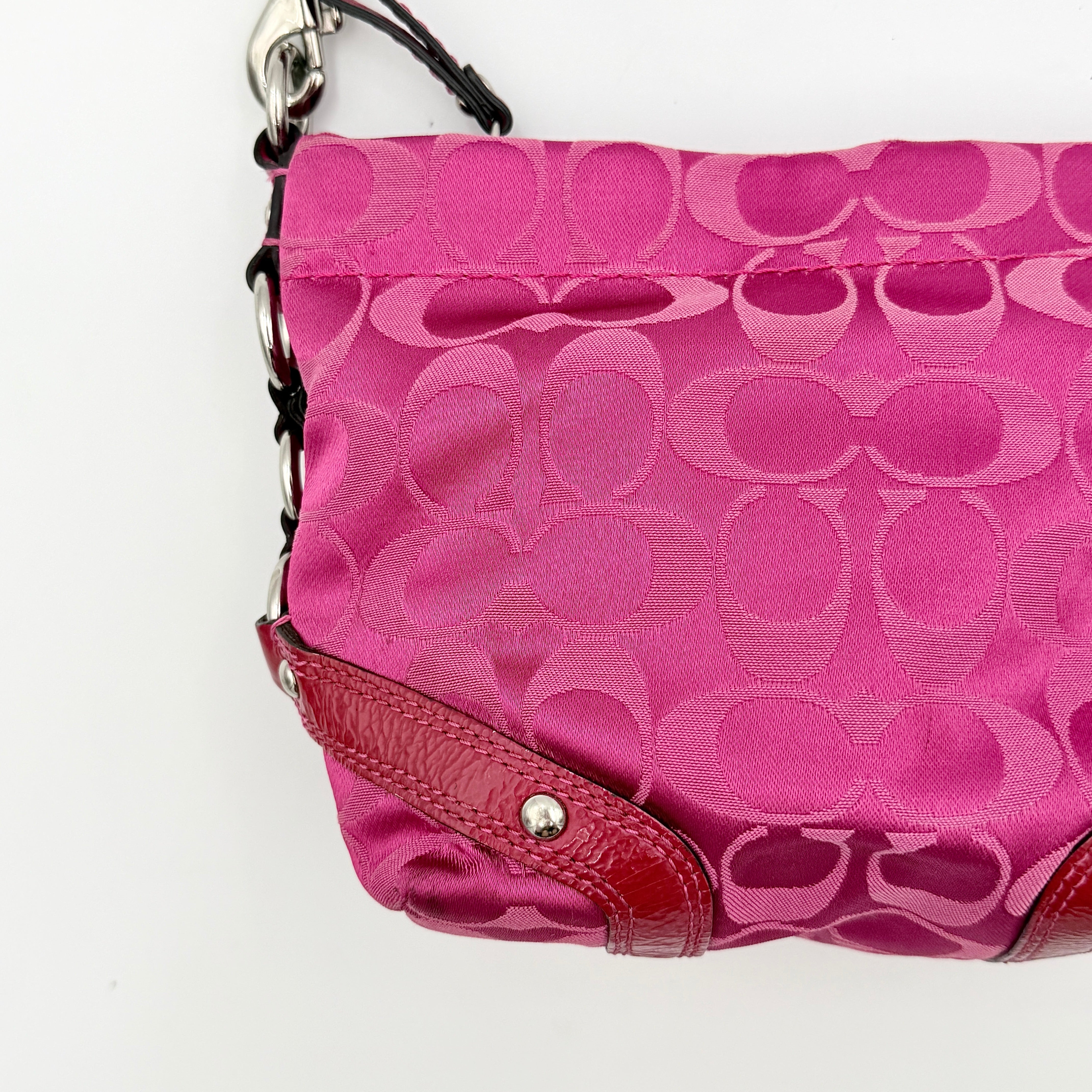 Coach Carly Hobo Shoulder Bag in vivid pink jacquard and leather, featuring signature chain detail and silver hardware.