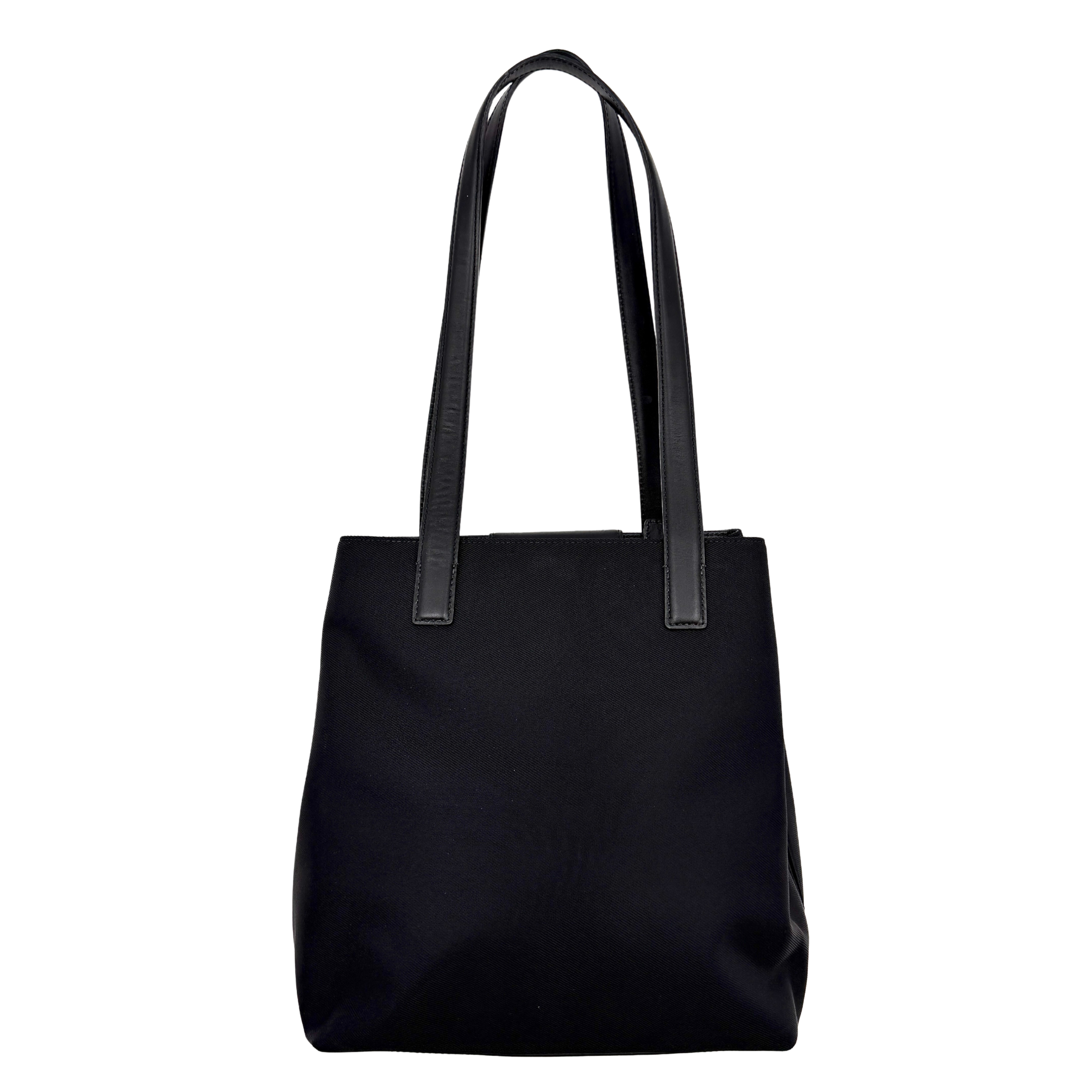 Coach Mercer Nylon Tote Bag in black with structured silhouette, leather handles, and subtle silver logo plaque at the base.