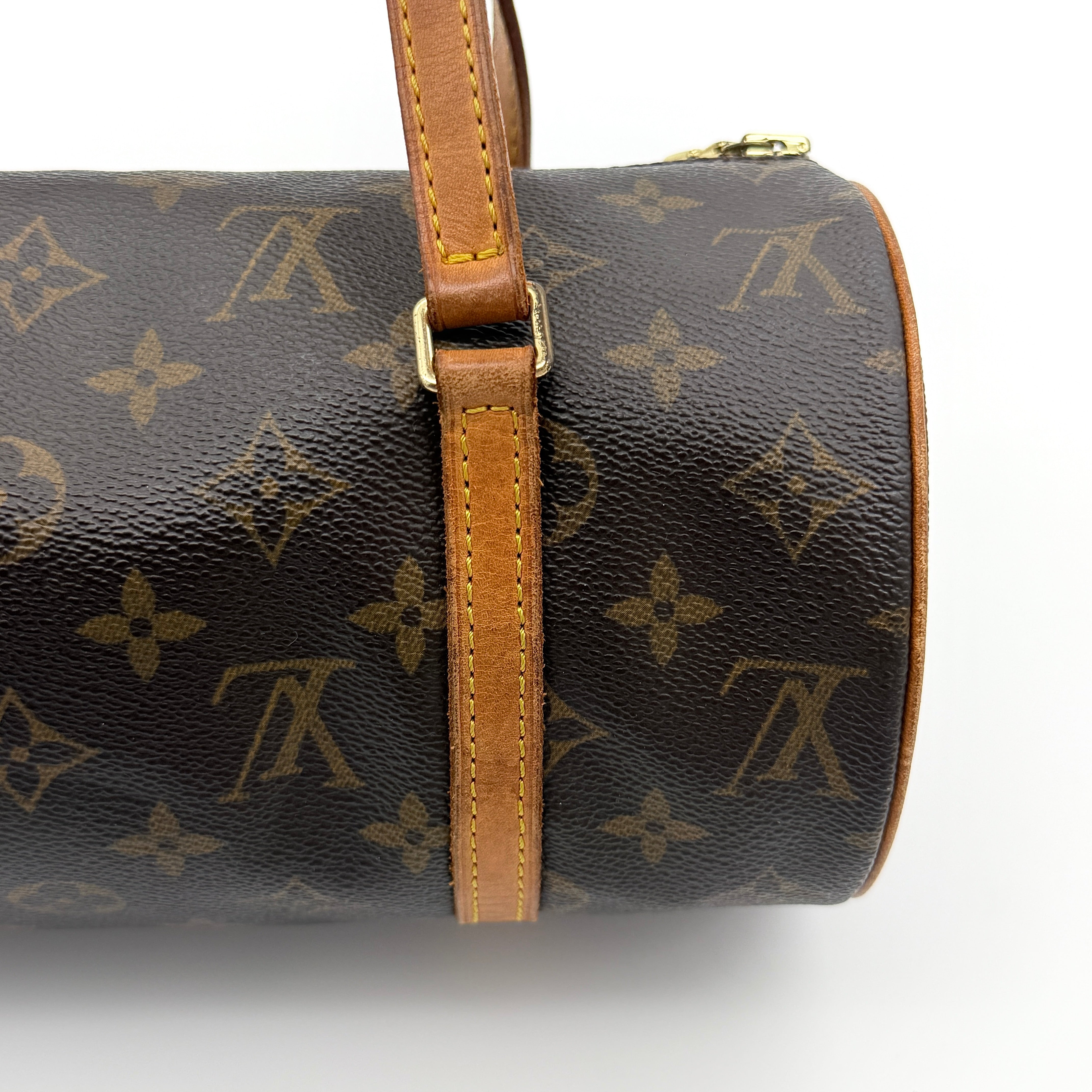 Louis Vuitton Papillon 26 in Monogram canvas with brown leather trim and gold-tone zip, shown against a white background.