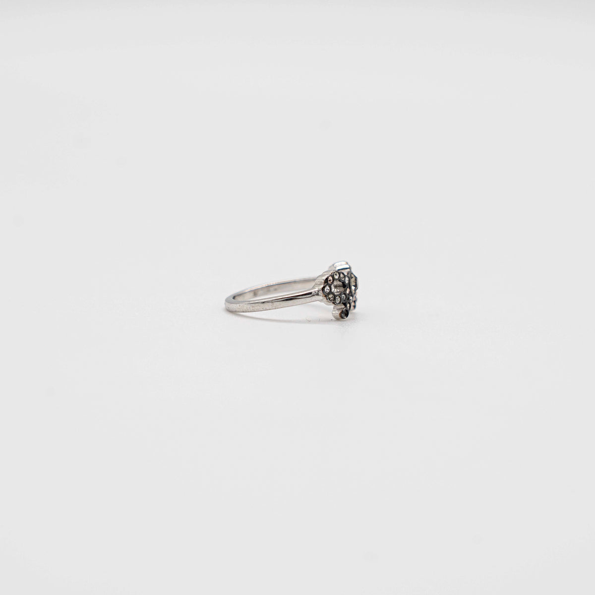 Coach silver ring with a rhinestone-encrusted bow motif, photographed against a white background.