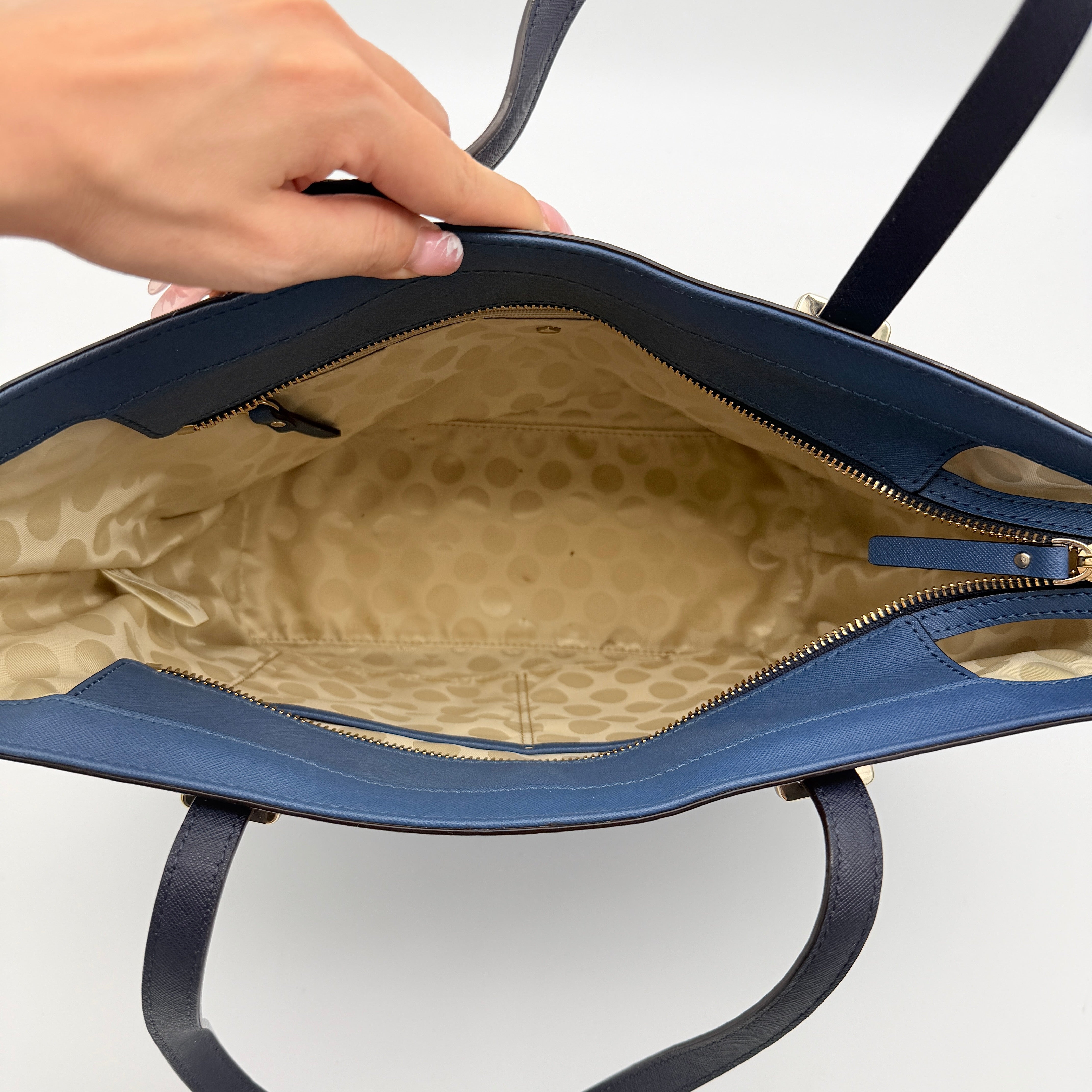 Kate Spade New York leather tote in two-tone blue with gold-tone hardware and structured handles.
