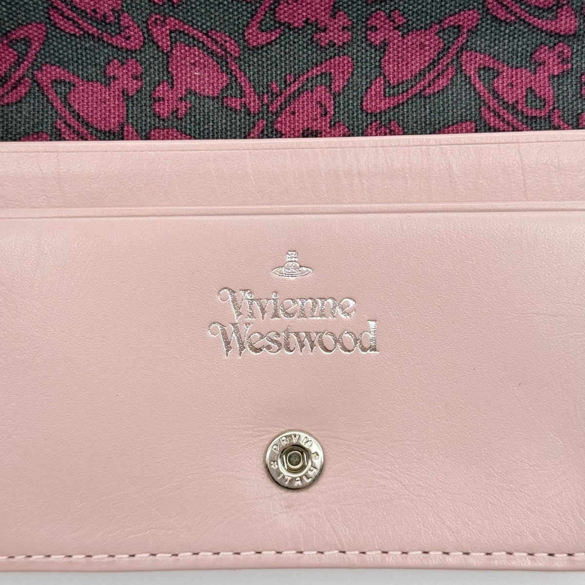 Vivienne Westwood light pink leather card case with silver-tone Orb emblem and sleek, structured design.